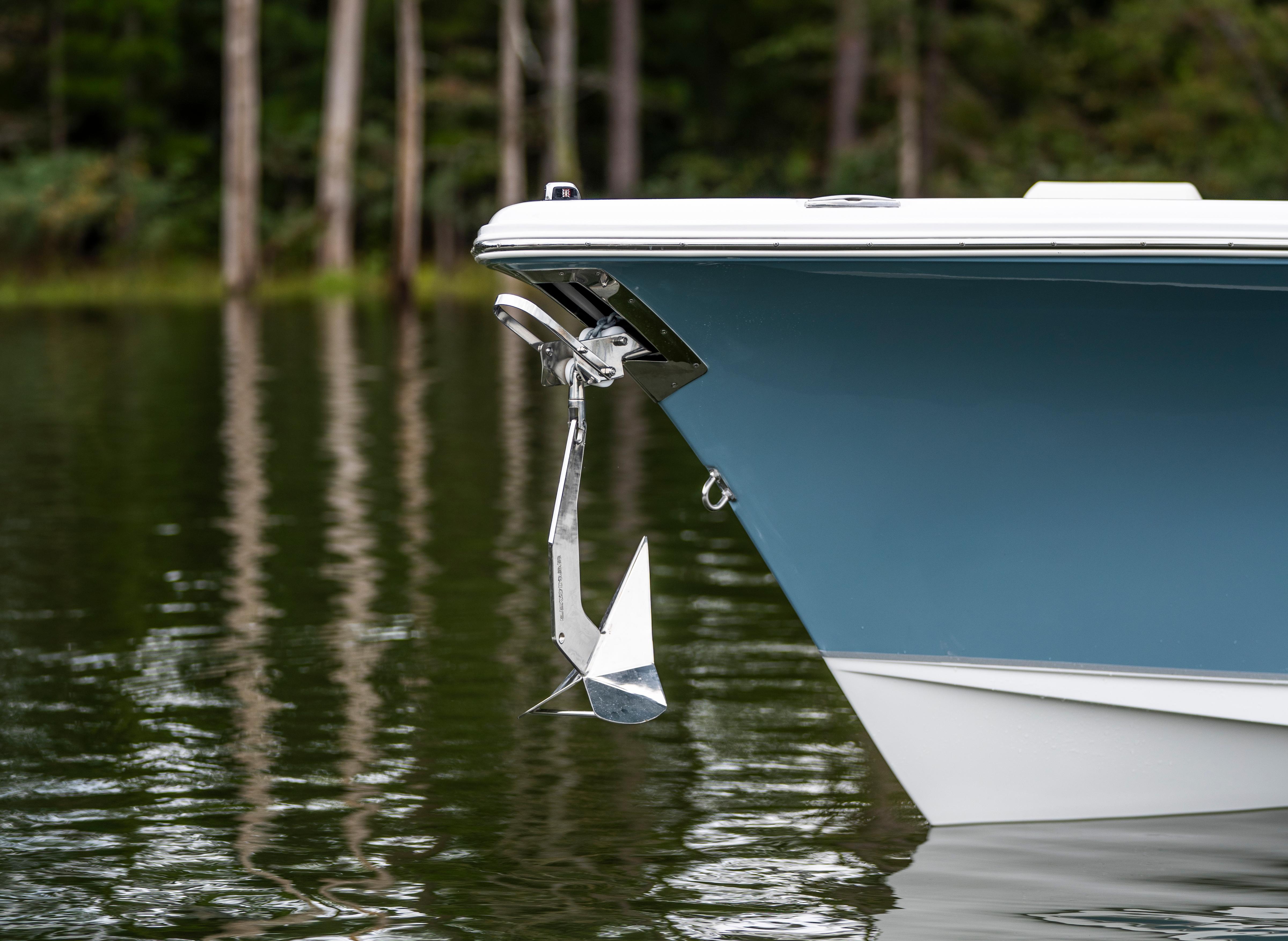 2026 Sea Hunt Ultra 245 SE boat with anchor in calm water.