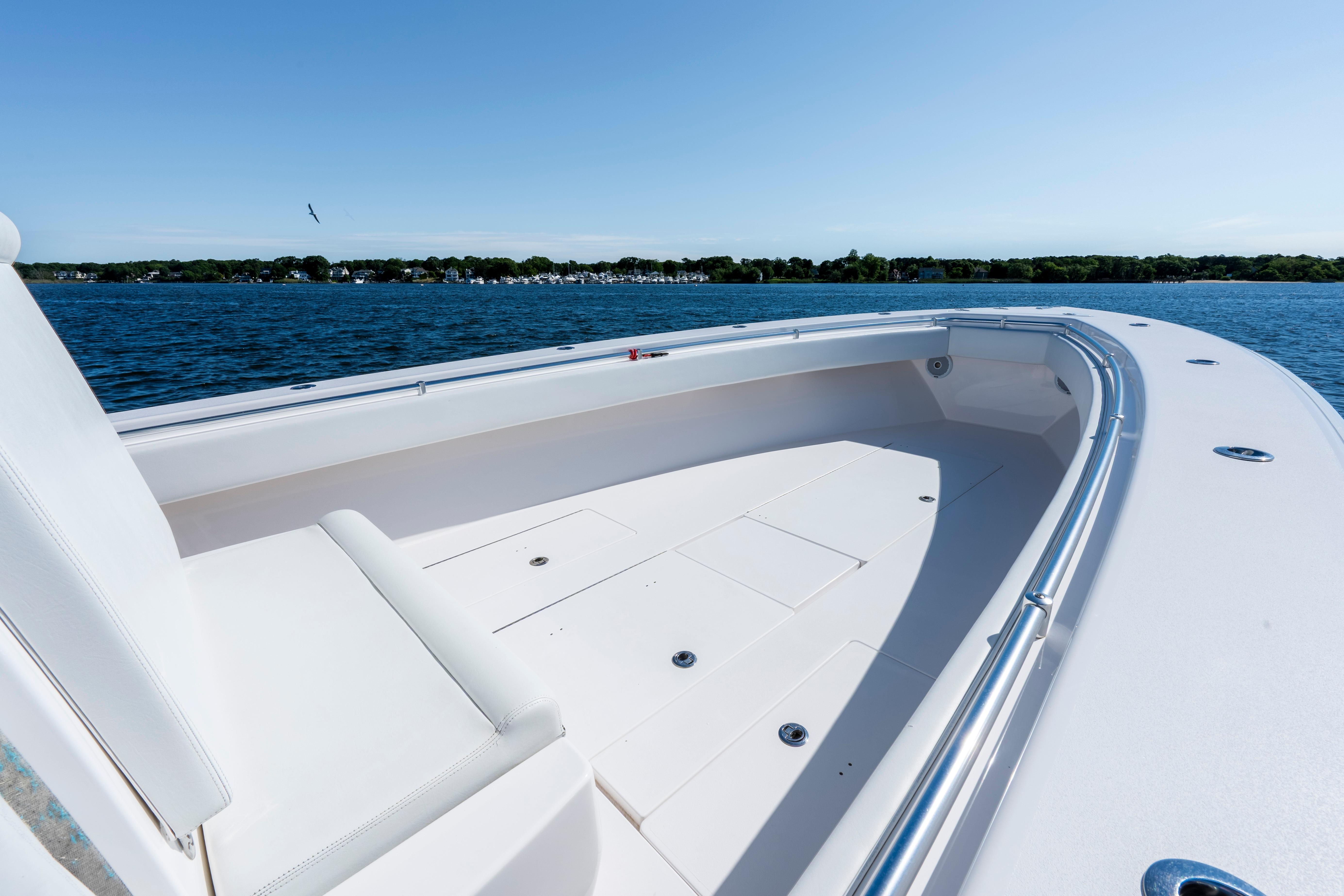 2015 Contender 39 ST boat on calm water, showcasing spacious deck and sleek design.