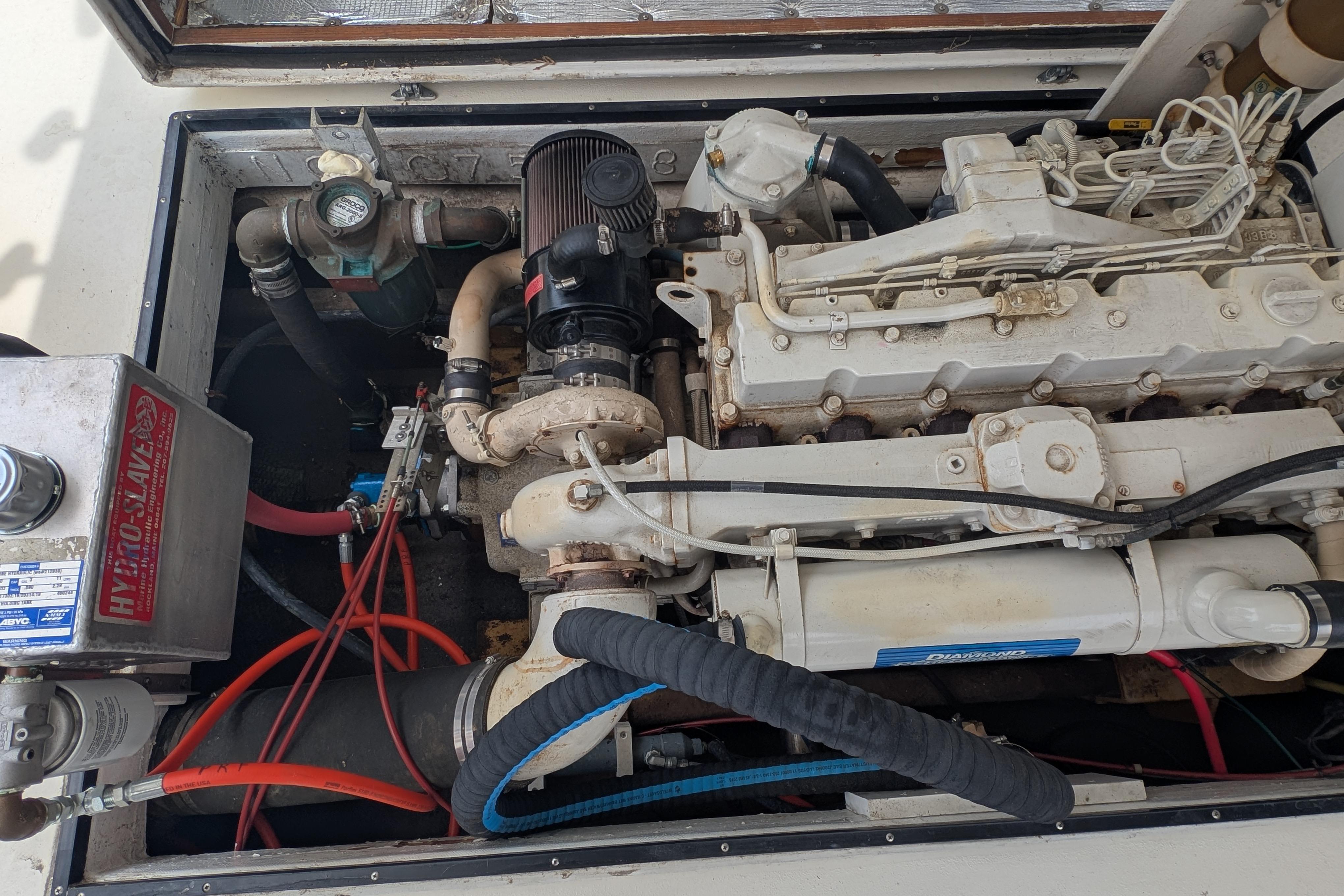 Engine compartment of a 1998 Markley 46 boat, showcasing mechanical components and wiring.