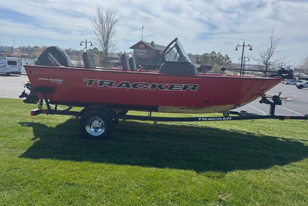 2026 Tracker Pro Guide V-16 WT boat on trailer, parked on grass under a clear sky.