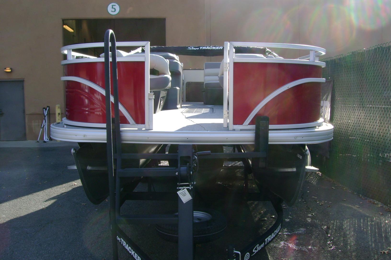 2026 Sun Tracker Fishin' Barge 22 XP3 pontoon boat, red exterior, parked outdoors.