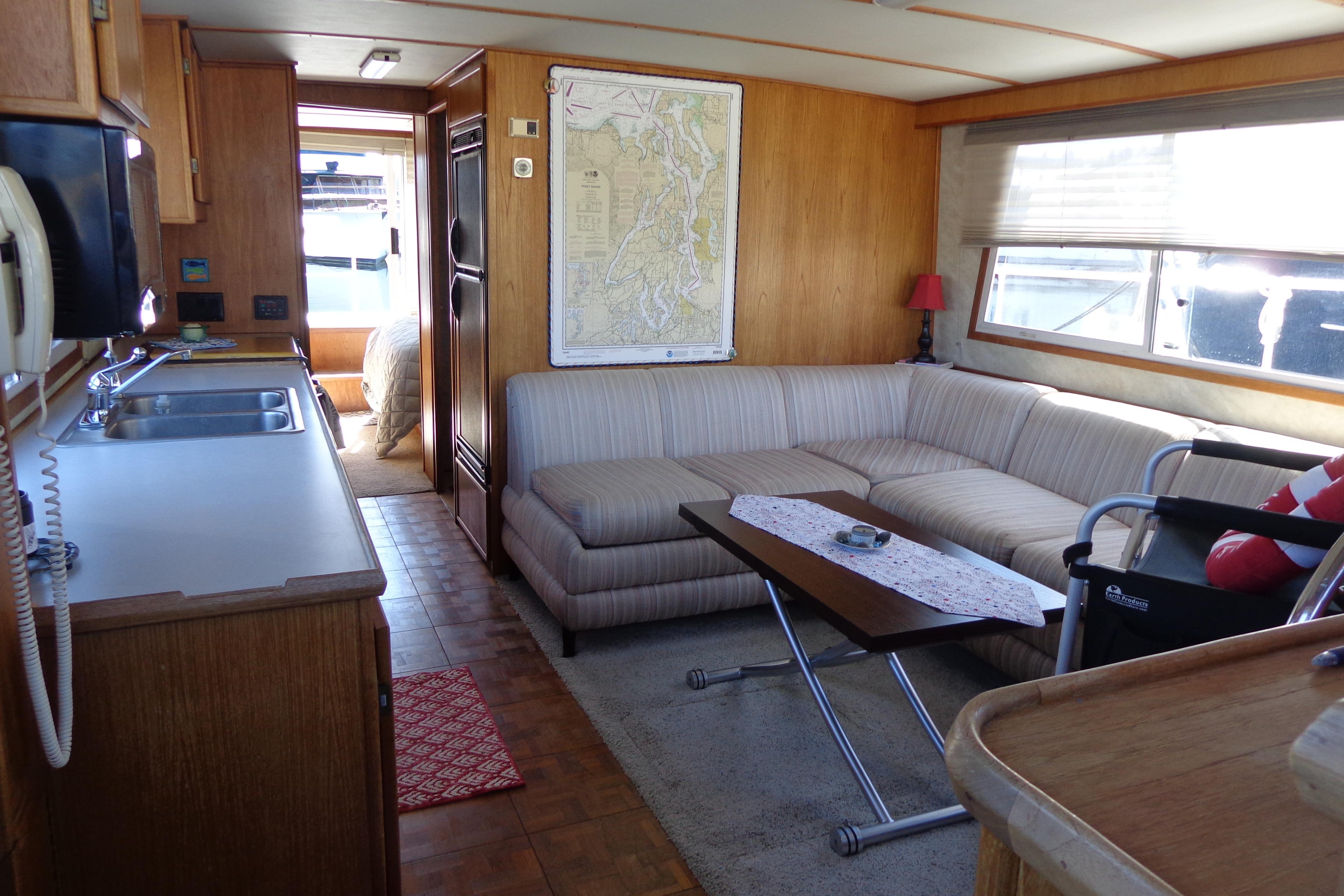 Interior of 1992 Cruise-A-Home Corsair 4200 with kitchen and cozy seating area.