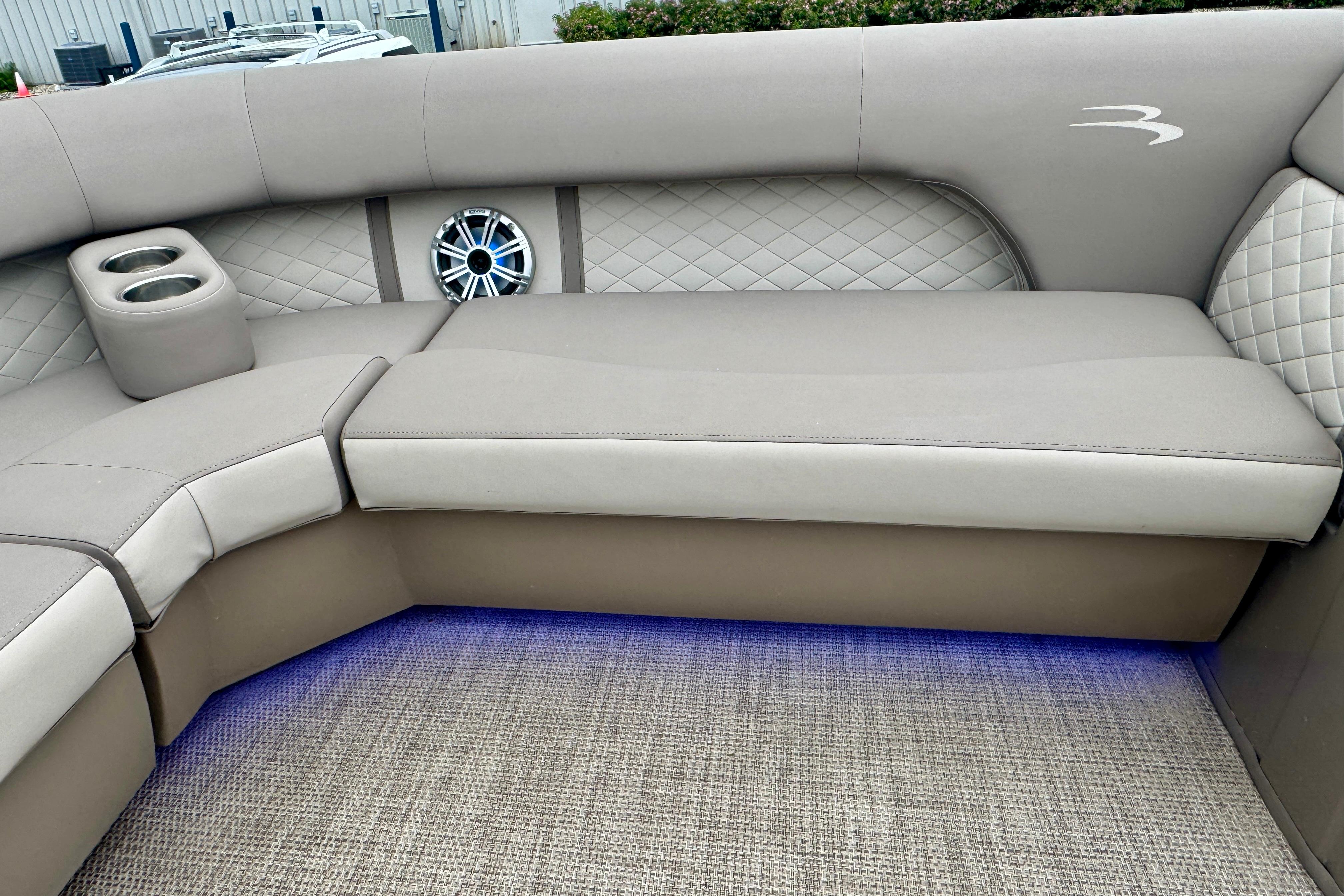 2019 Bennington SX 22 SSBXP boat interior with cushioned seating and ambient lighting.