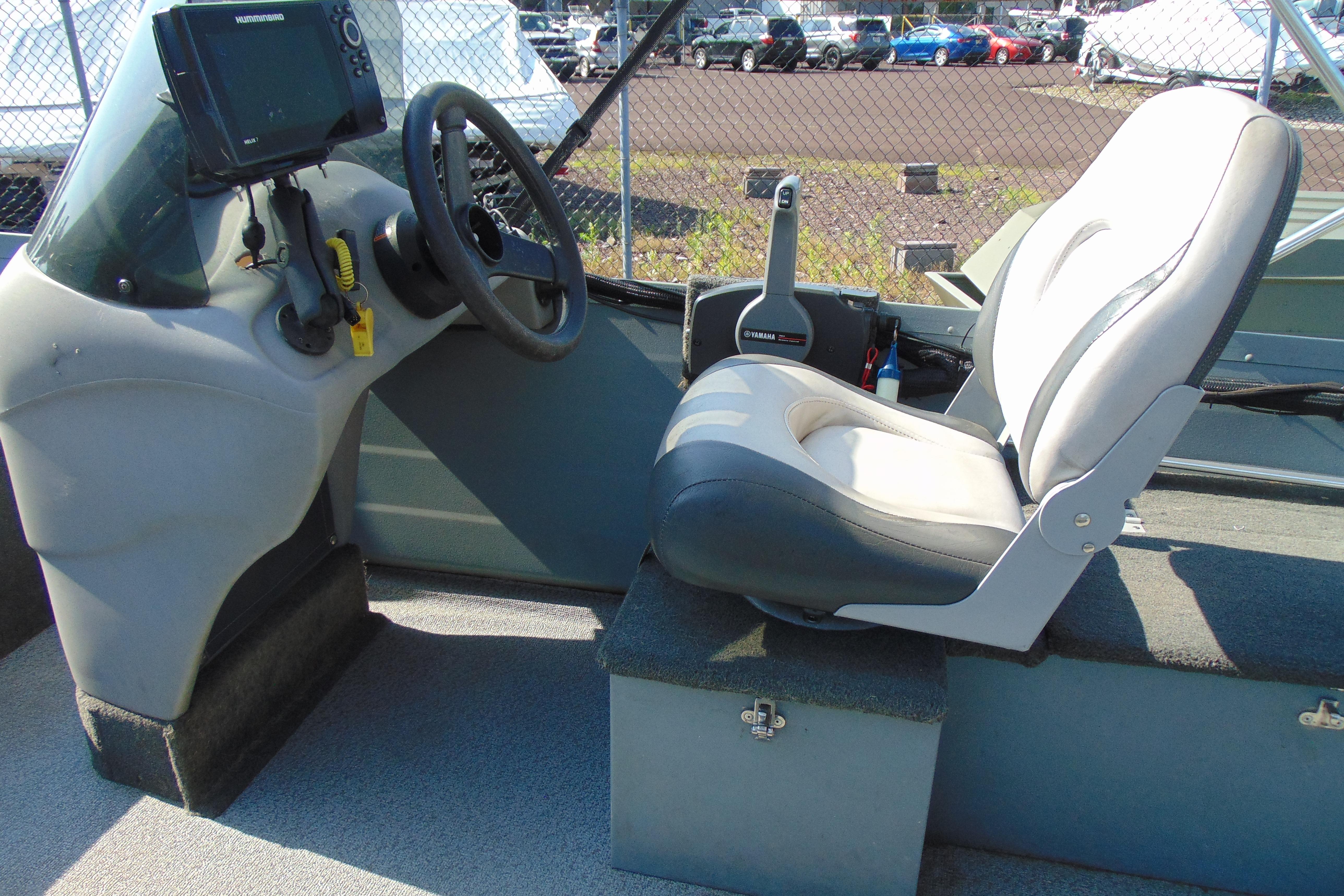 2017 Starcraft SF 16 DLX boat interior with steering wheel and cushioned seat.