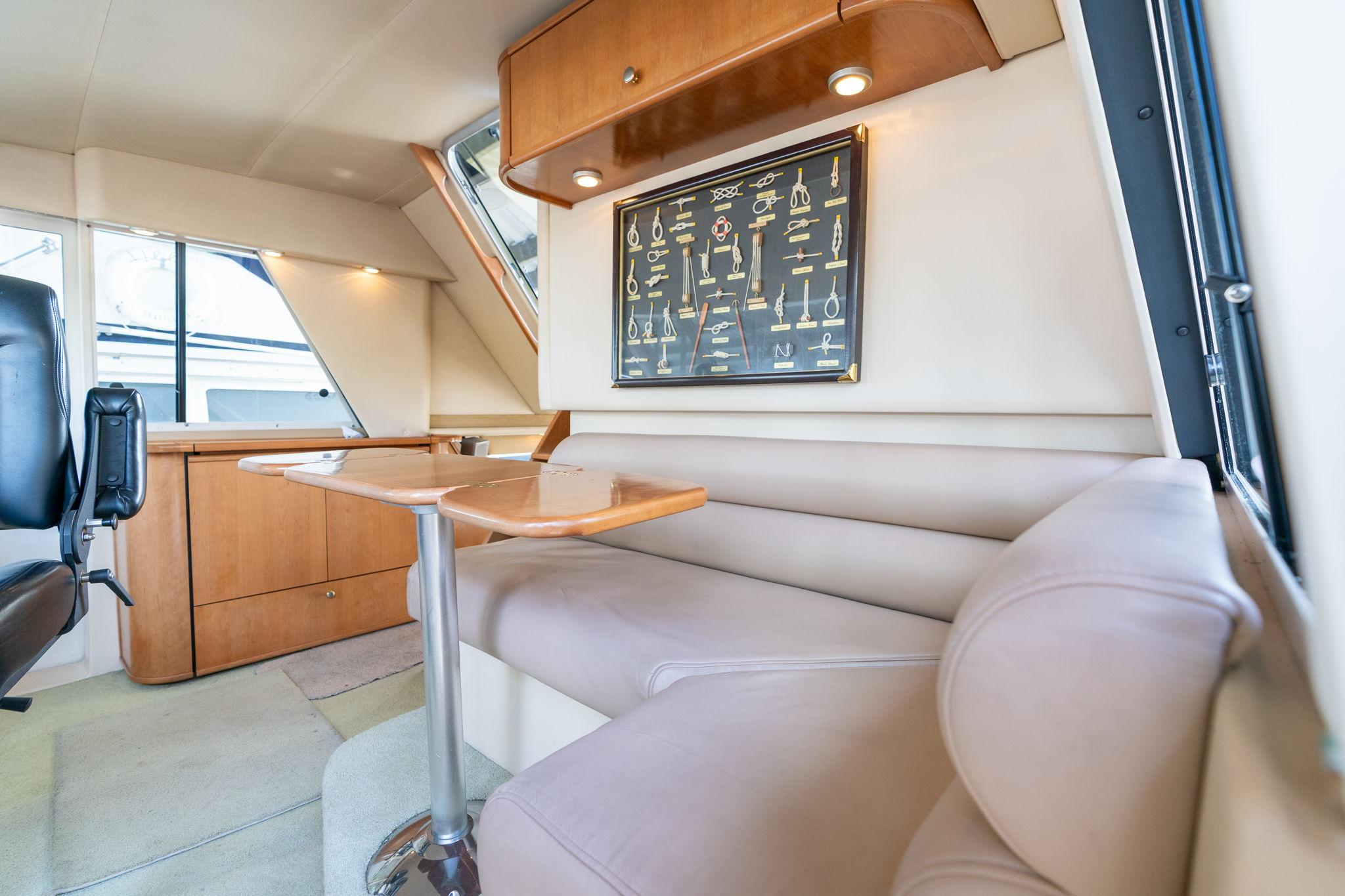 Luxurious interior of 2003 Meridian 490 Pilothouse with plush seating and elegant wood finishes.