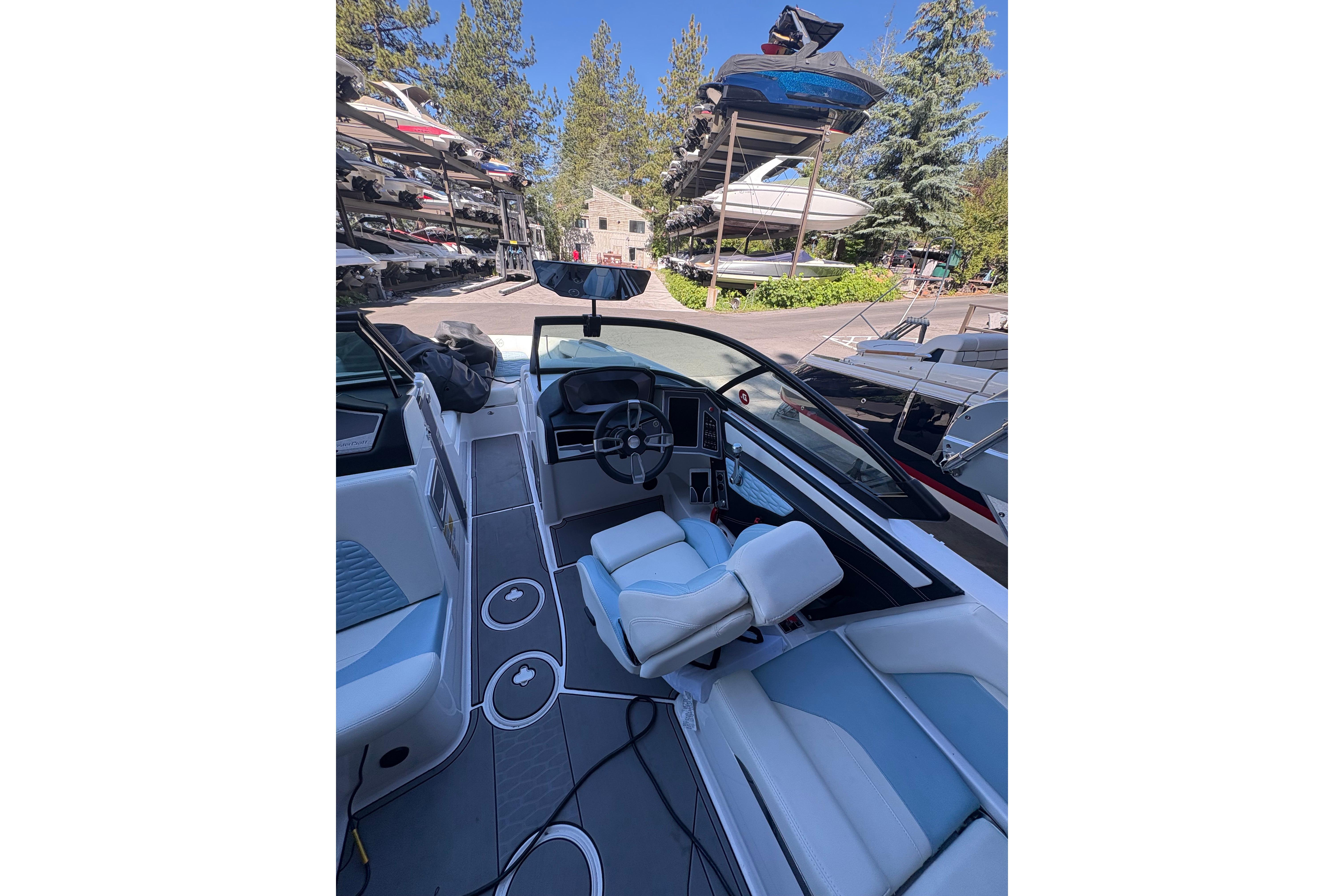 Interior view of 2022 MasterCraft X24 boat with modern dashboard and seating.