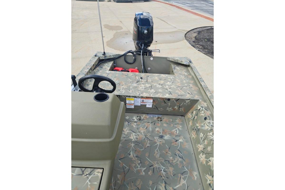 2025 Tracker Grizzly 1648 SC boat with camouflage design and outboard motor.