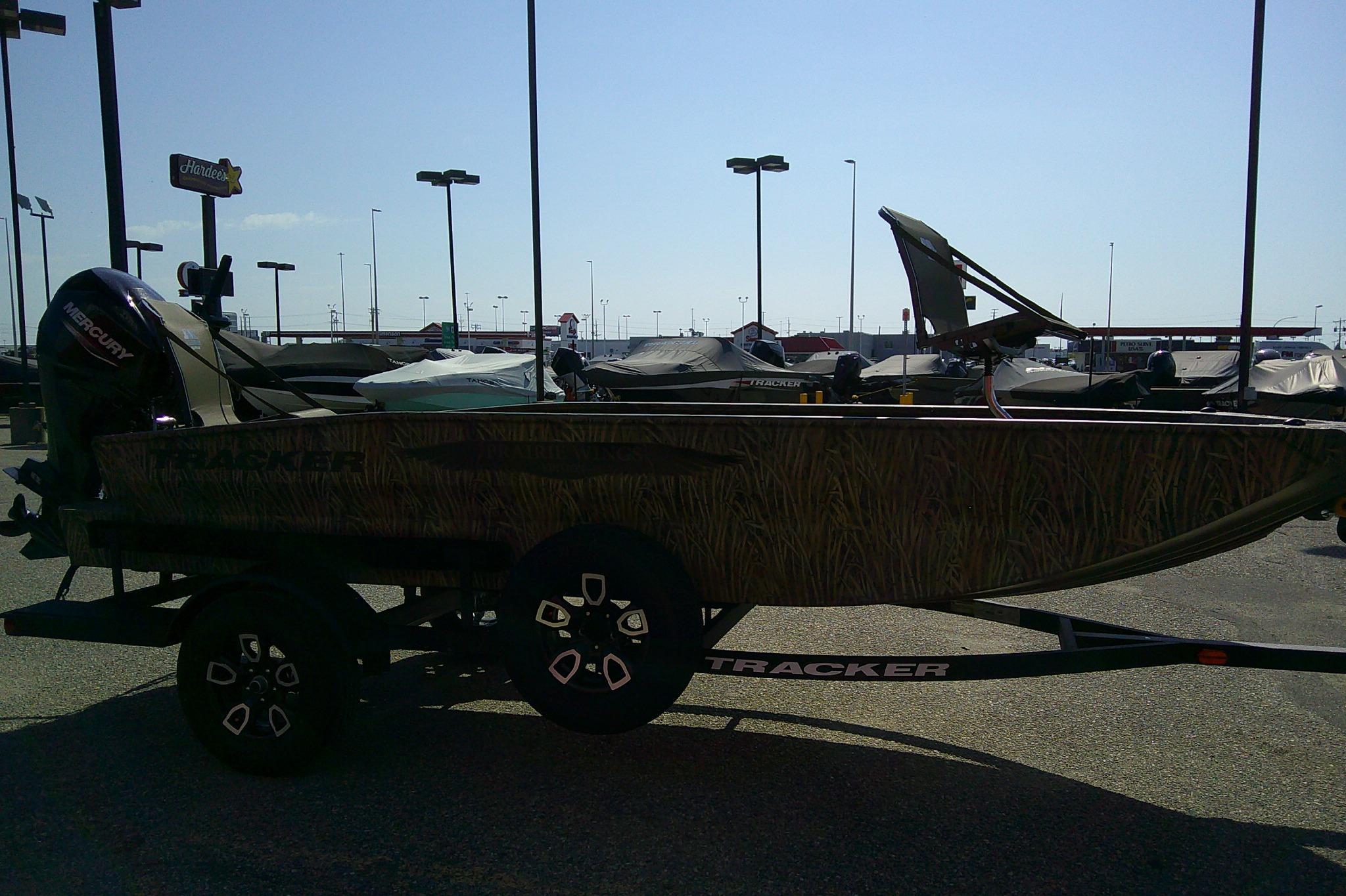 2026 Tracker Grizzly 1650 T Prairie Wings Edition boat on trailer in parking lot.