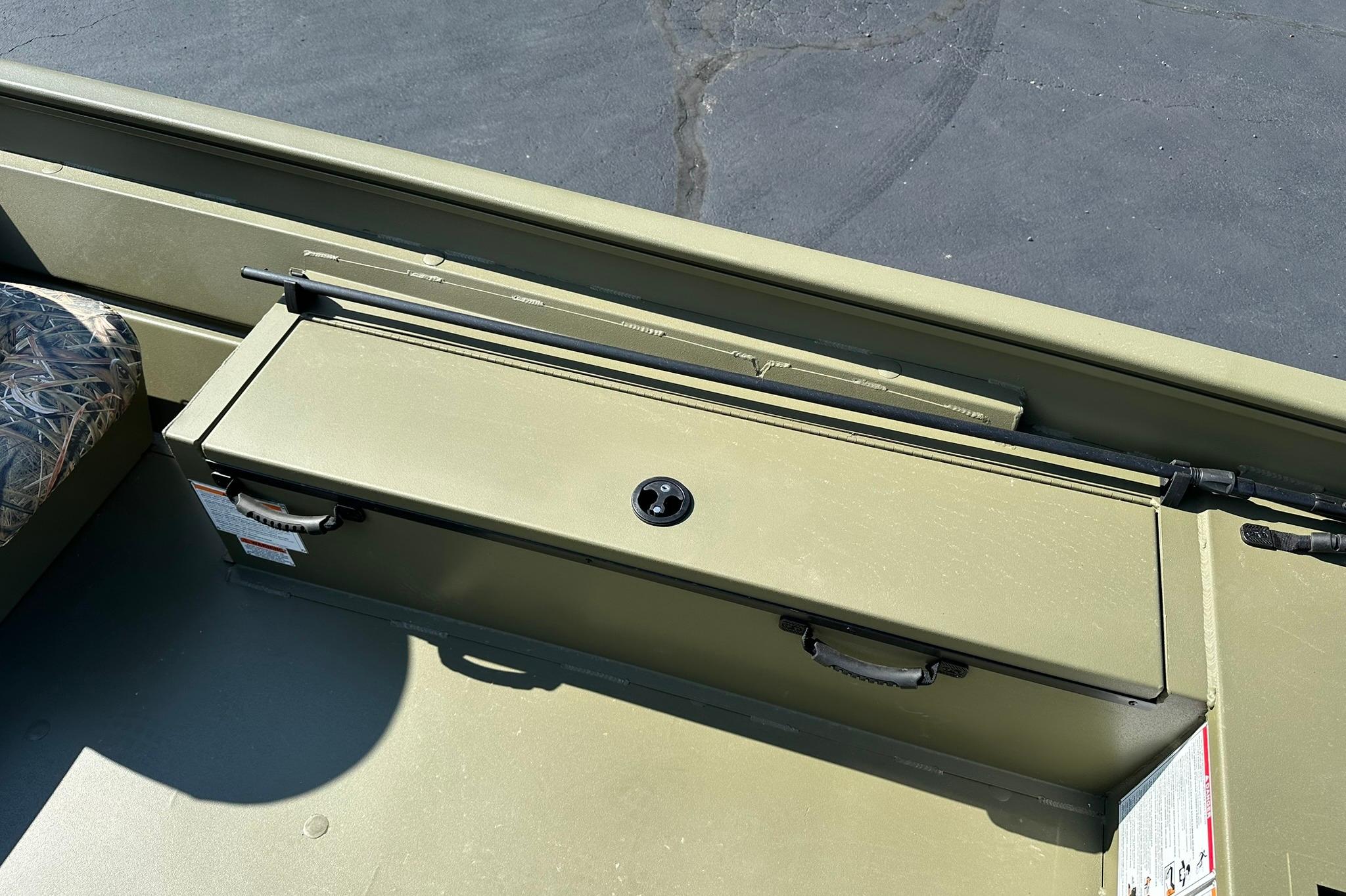 2026 Lowe Roughneck 1860SC boat interior with storage compartment and camouflage seat.