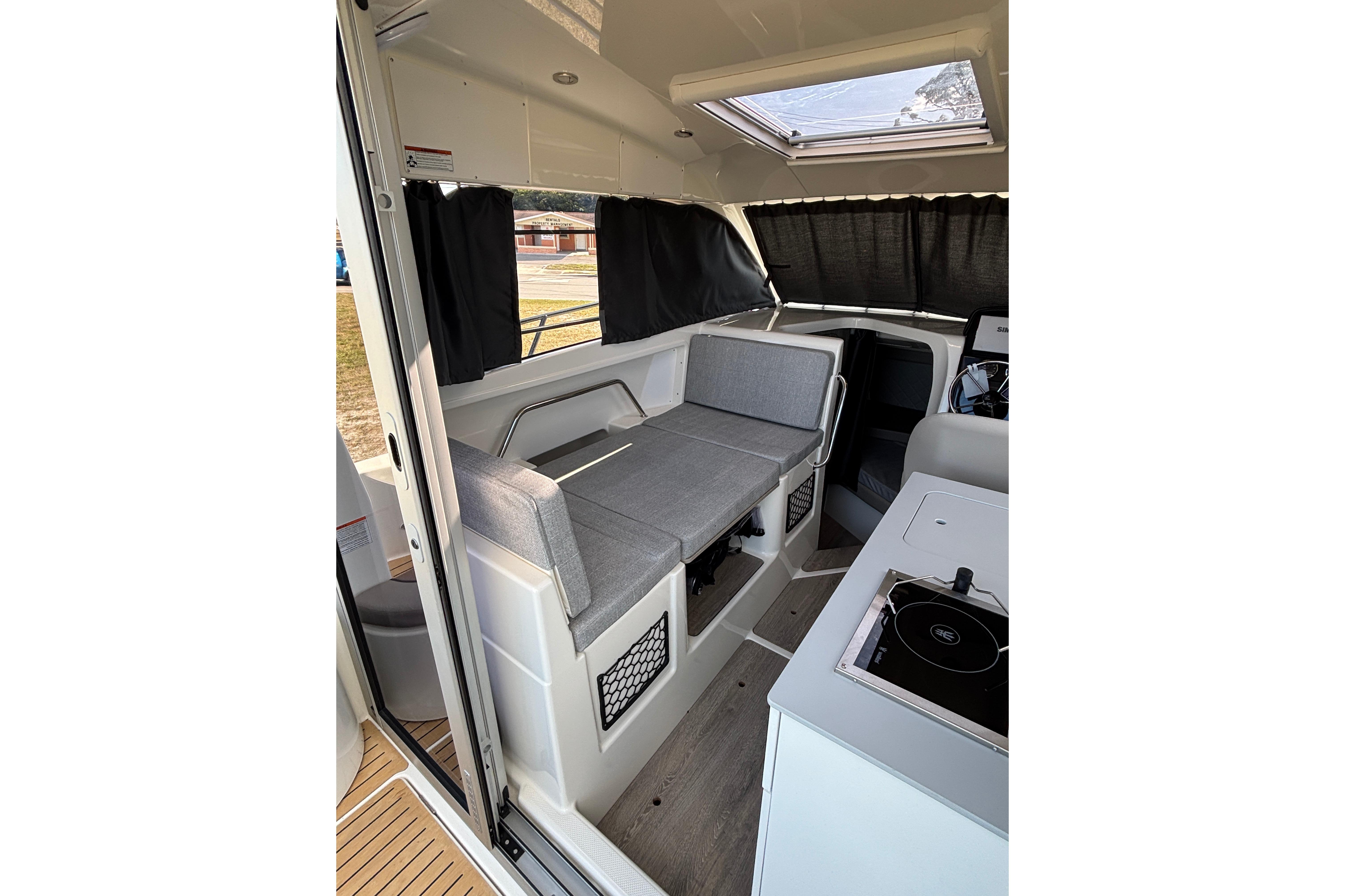 Interior of 2026 Trophy T 25 Explorer boat with seating and kitchenette.