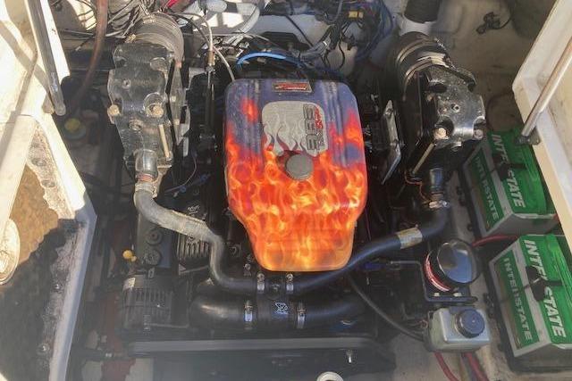 Engine of a 2006 Sea Ray 270 Sundeck with flame design cover.