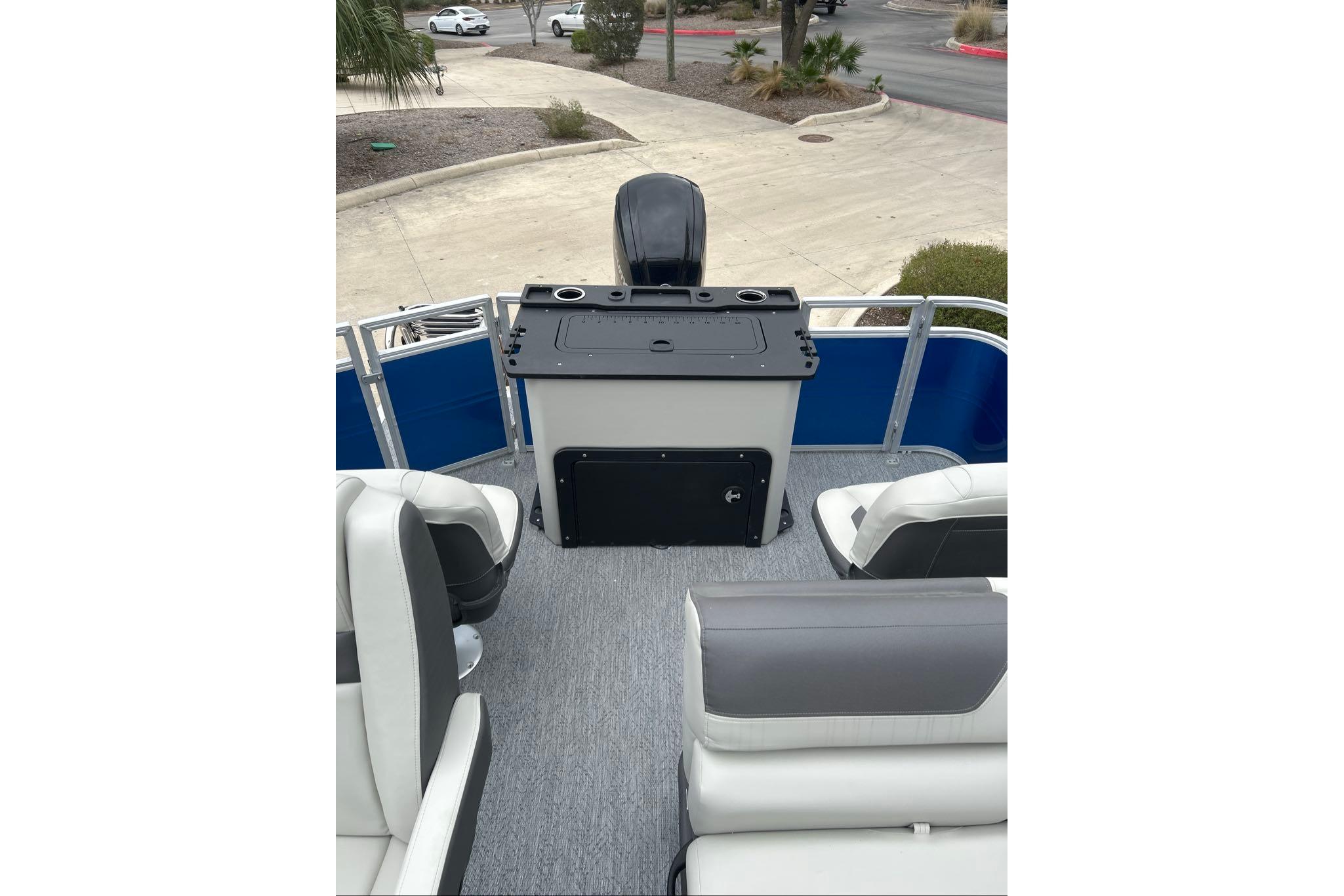 2026 Sun Tracker Fishin' Barge 20 DLX interior with seating and control panel.