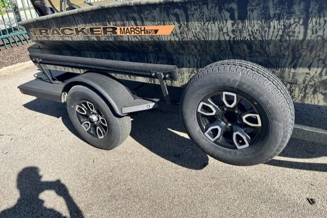 2026 Tracker Grizzly 1756 T Marsh boat trailer with black wheels on pavement.
