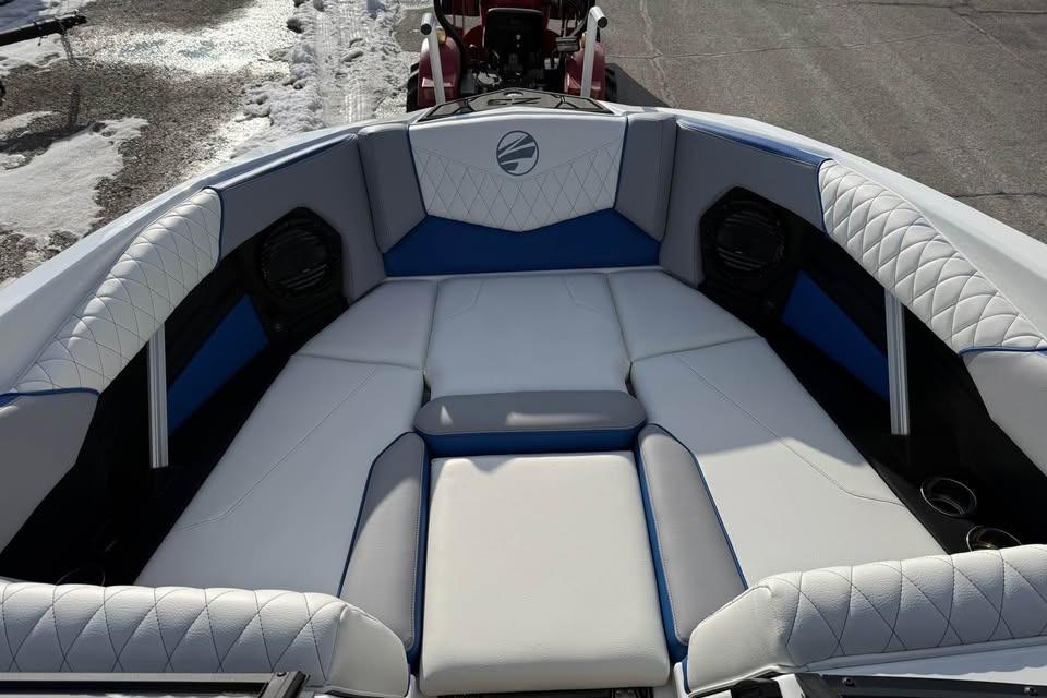 2026 Tigé Z3 boat interior with white and blue cushioned seating.