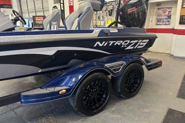 2026 Nitro Z19 XL boat with sleek design and dual-axle trailer in showroom.