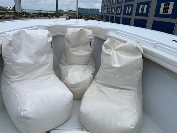 Three white bean bag chairs on a 2022 Yellowfin 39 Offshore boat deck.