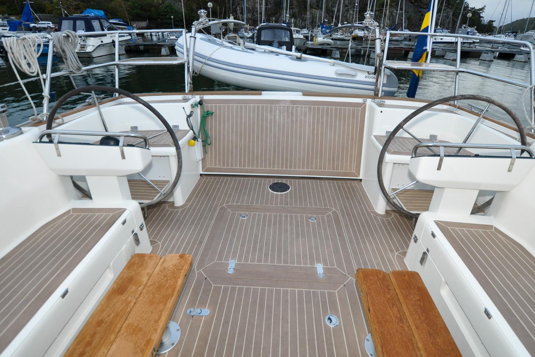 Modern Heyman 42PPH yacht cockpit with dual steering wheels, docked at marina, 2023 model.