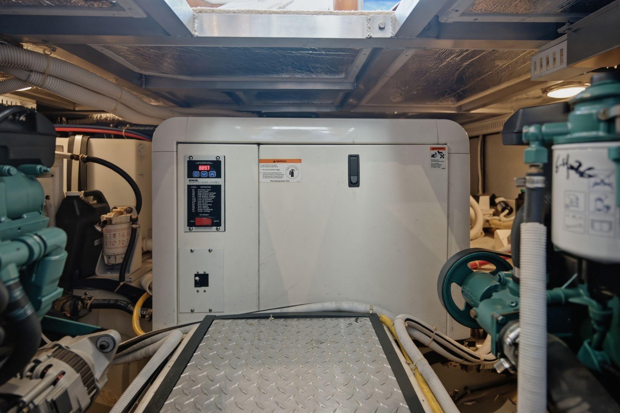 Engine room of 2005 Carver 39 Motor Yacht with generator and mechanical components.