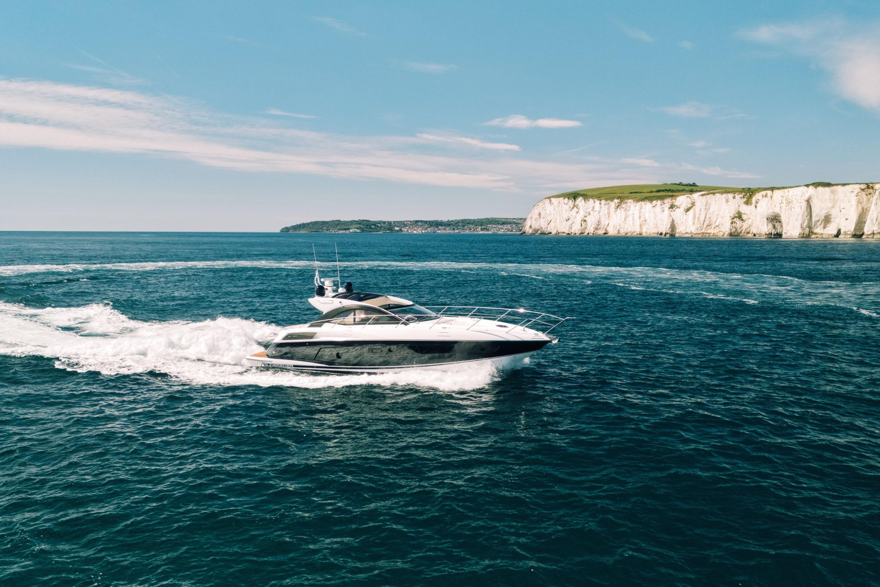 Sunseeker San Remo 485 yacht cruising near white cliffs, 2013 model.