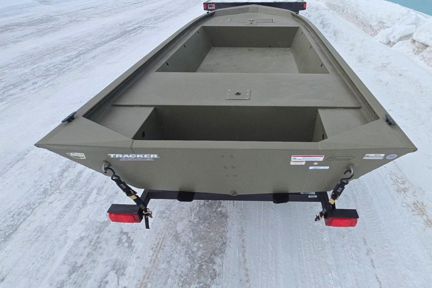 2025 Tracker Grizzly 1648 Jon boat on snowy ground, rear view.