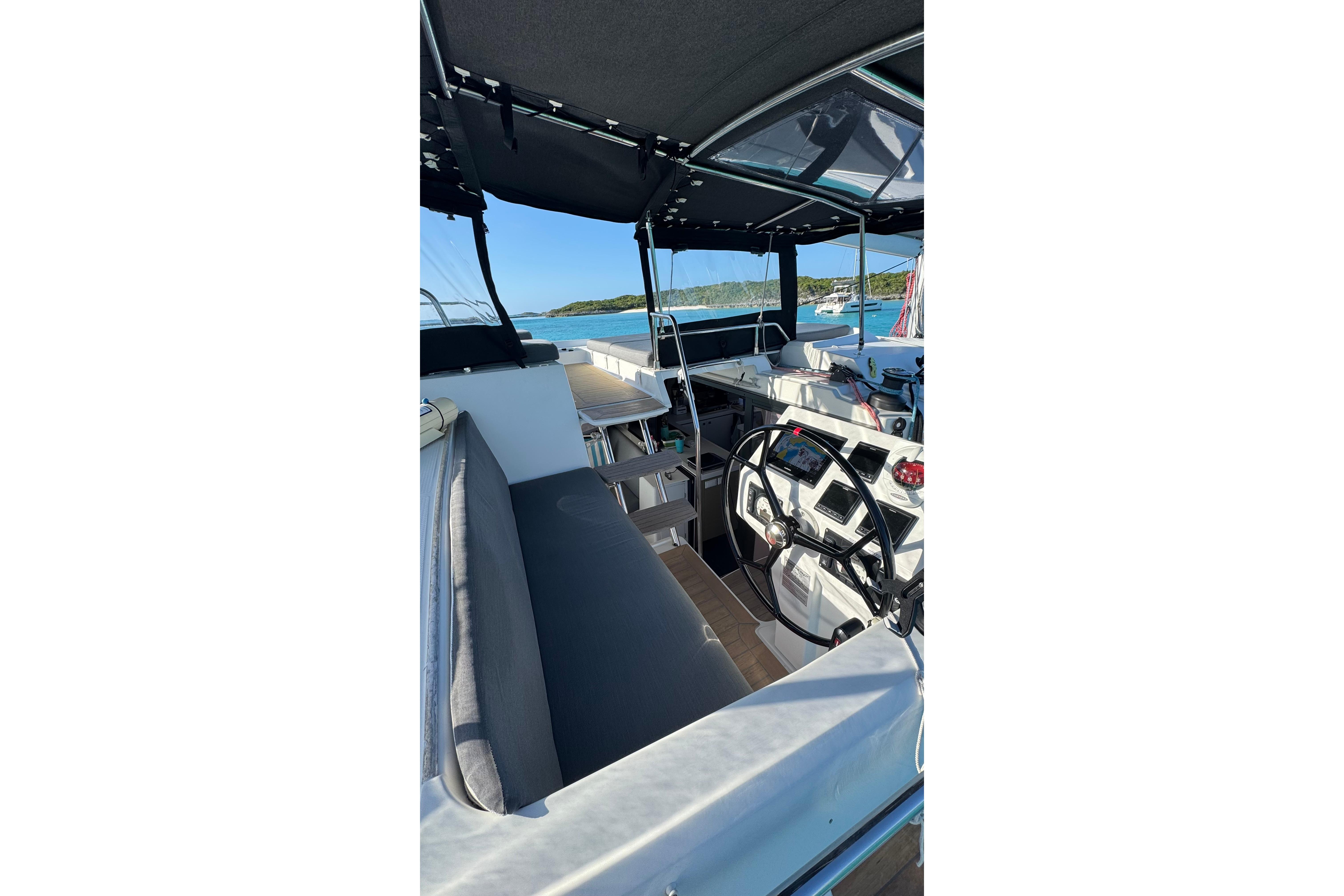Cockpit view of 2020 Fountaine Pajot Saona 47 catamaran with seating and steering wheel.