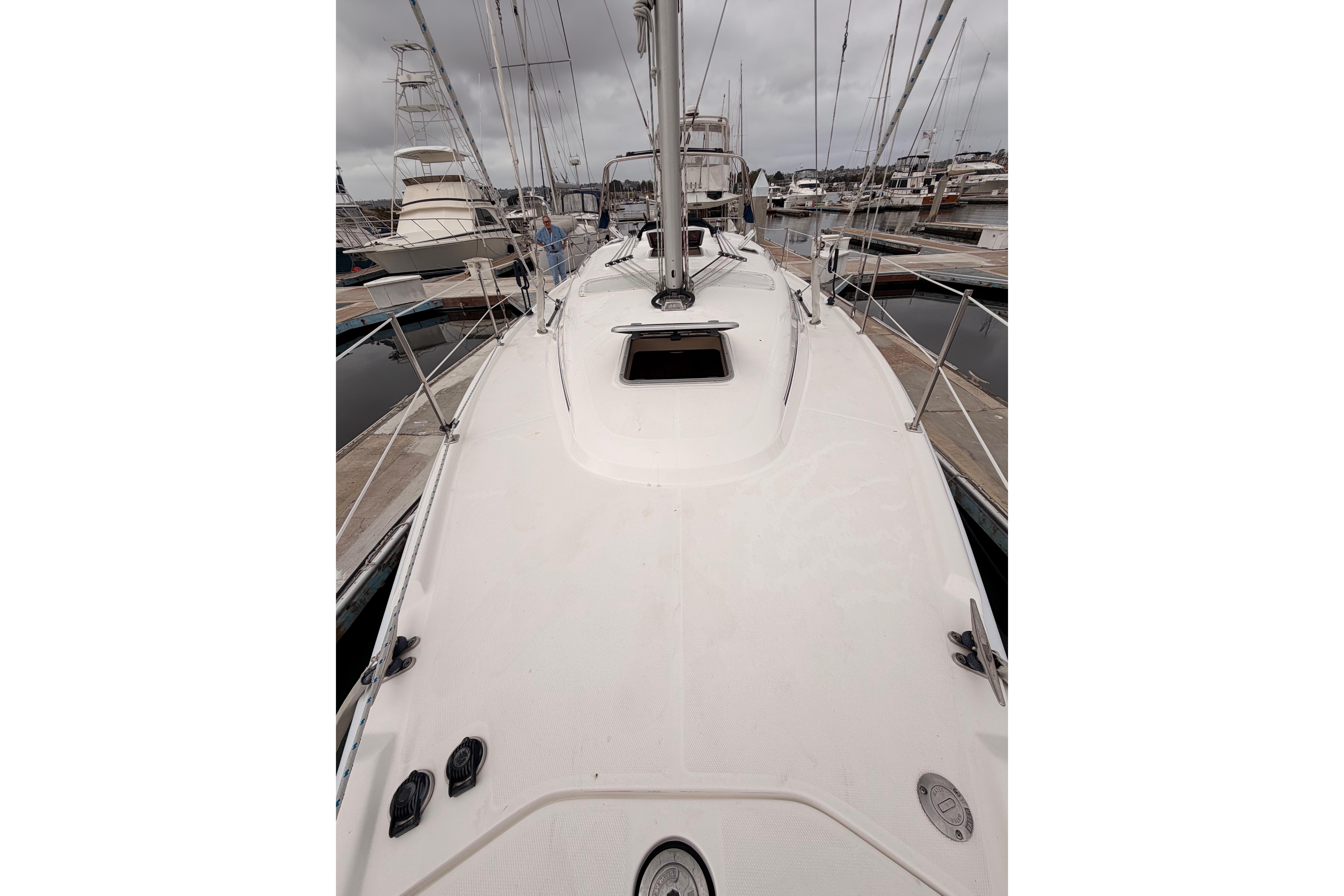 2009 Hunter 38 sailboat deck view at marina, overcast sky.