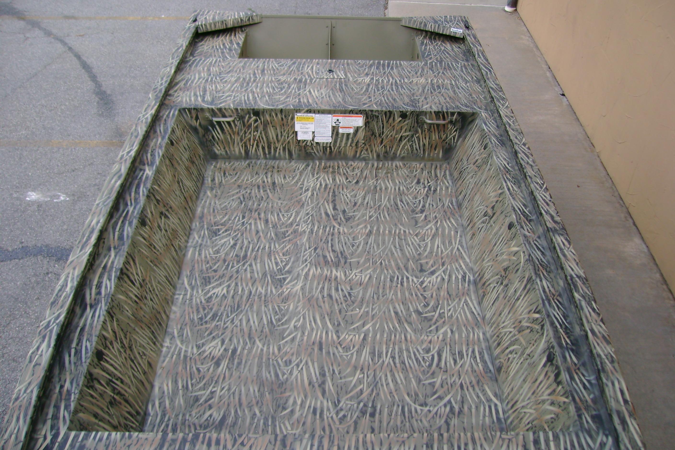 2026 Tracker Grizzly 1648 Utility boat with camouflage interior design.