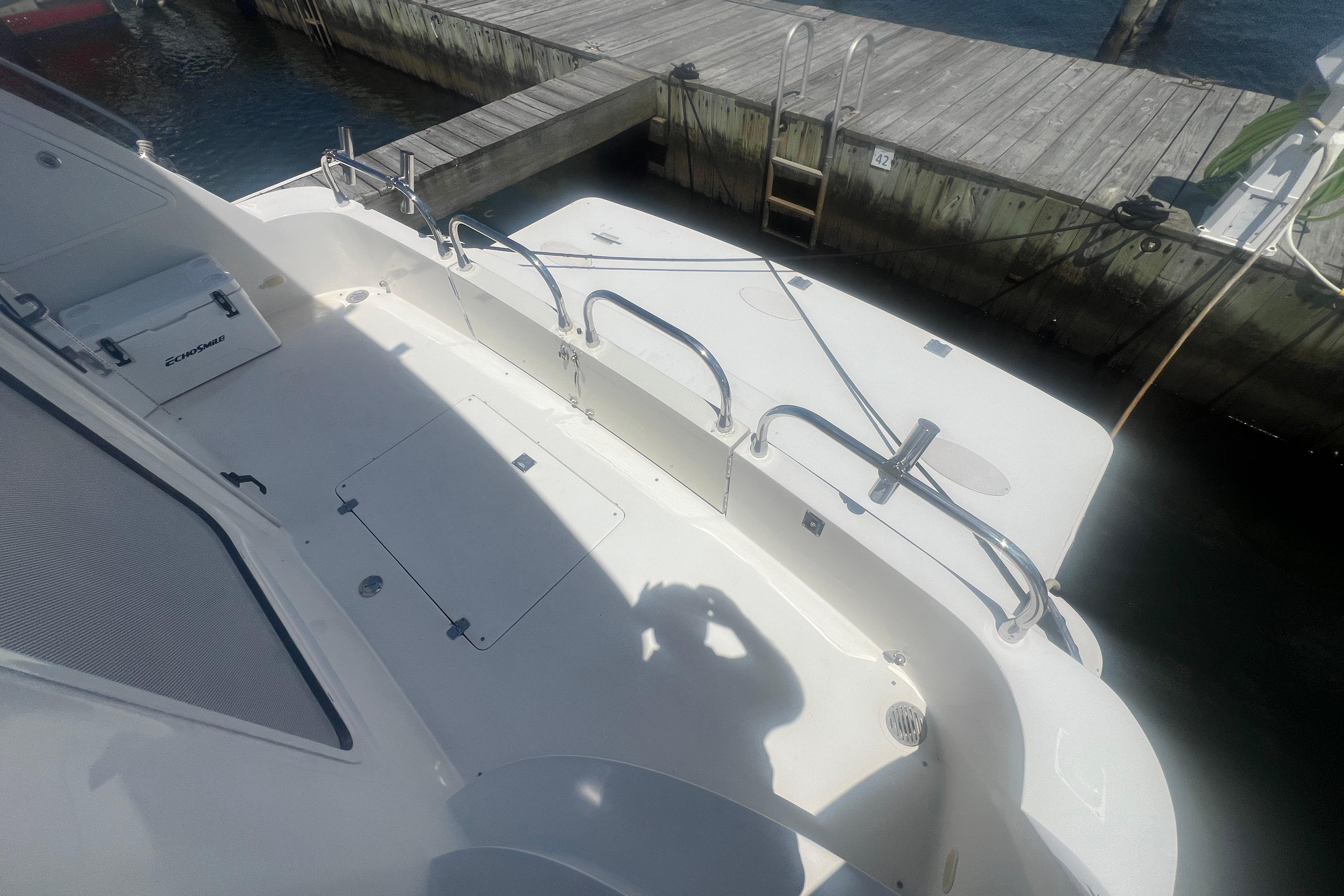 2006 Carver 43 Motor Yacht docked, featuring spacious deck and safety railings.