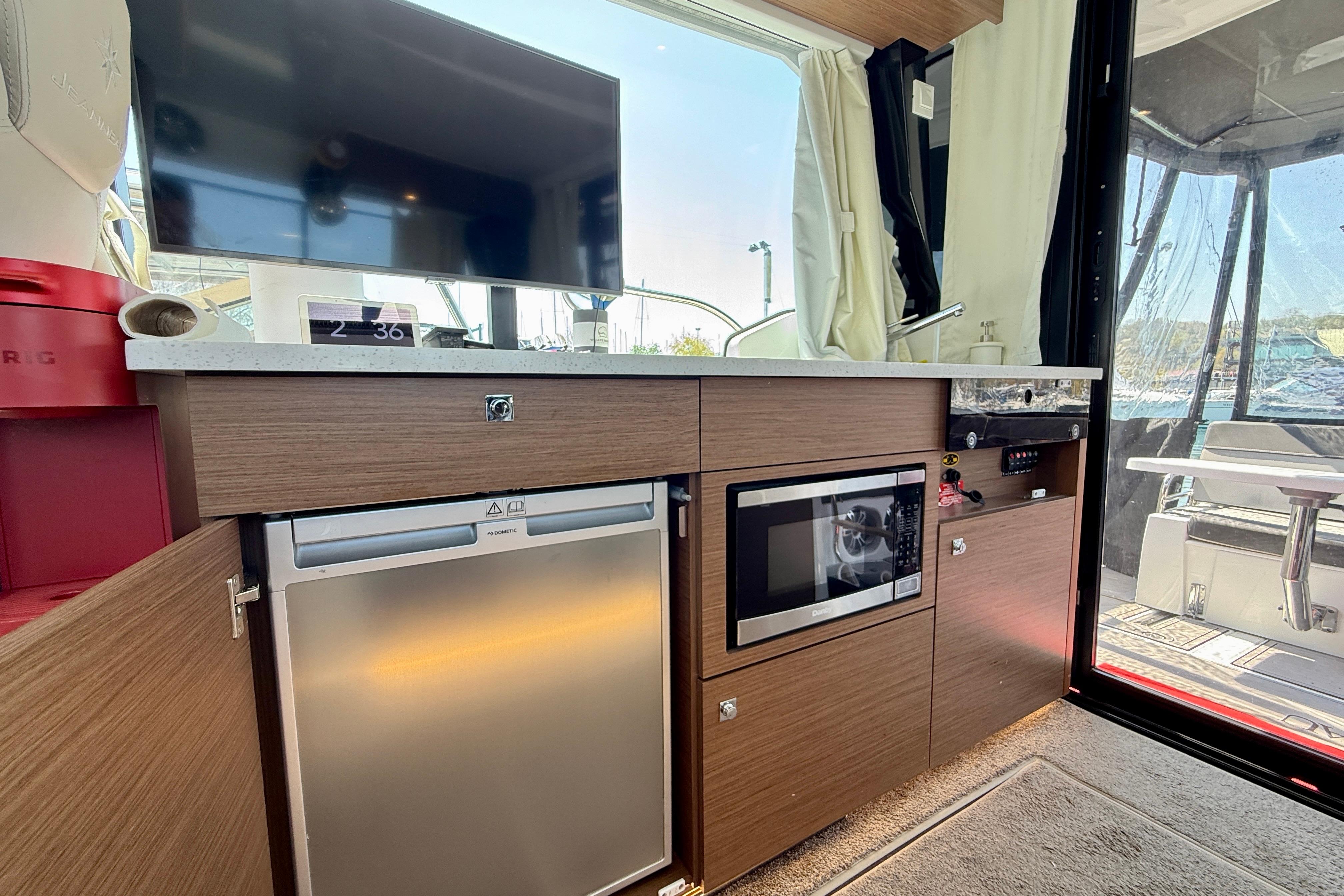 Interior of 2022 Jeanneau NC 1095 Fly yacht with modern kitchen amenities.