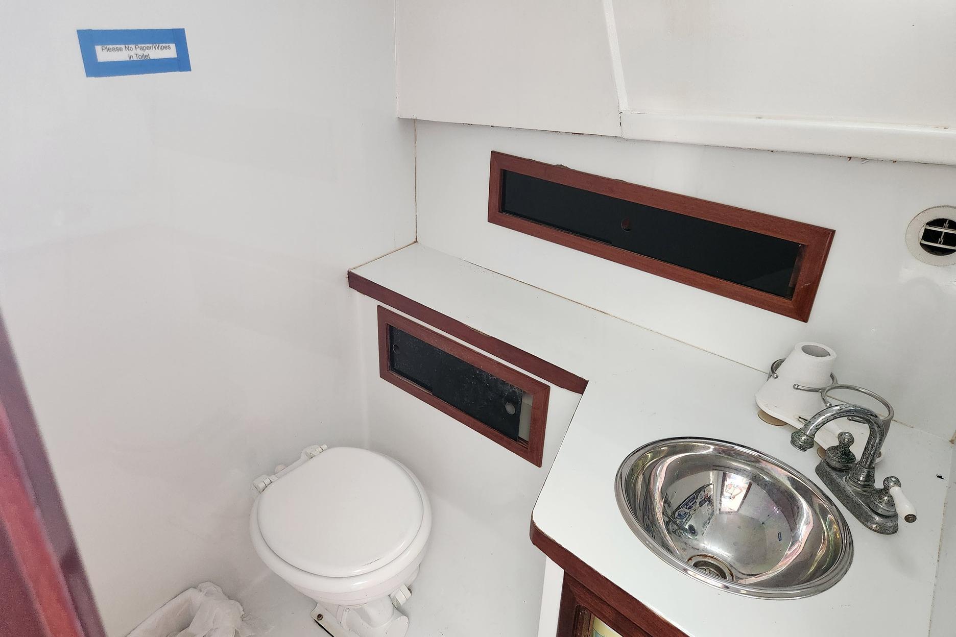 1987 Young Brothers Custom Sport Fish boat bathroom with sink and toilet.