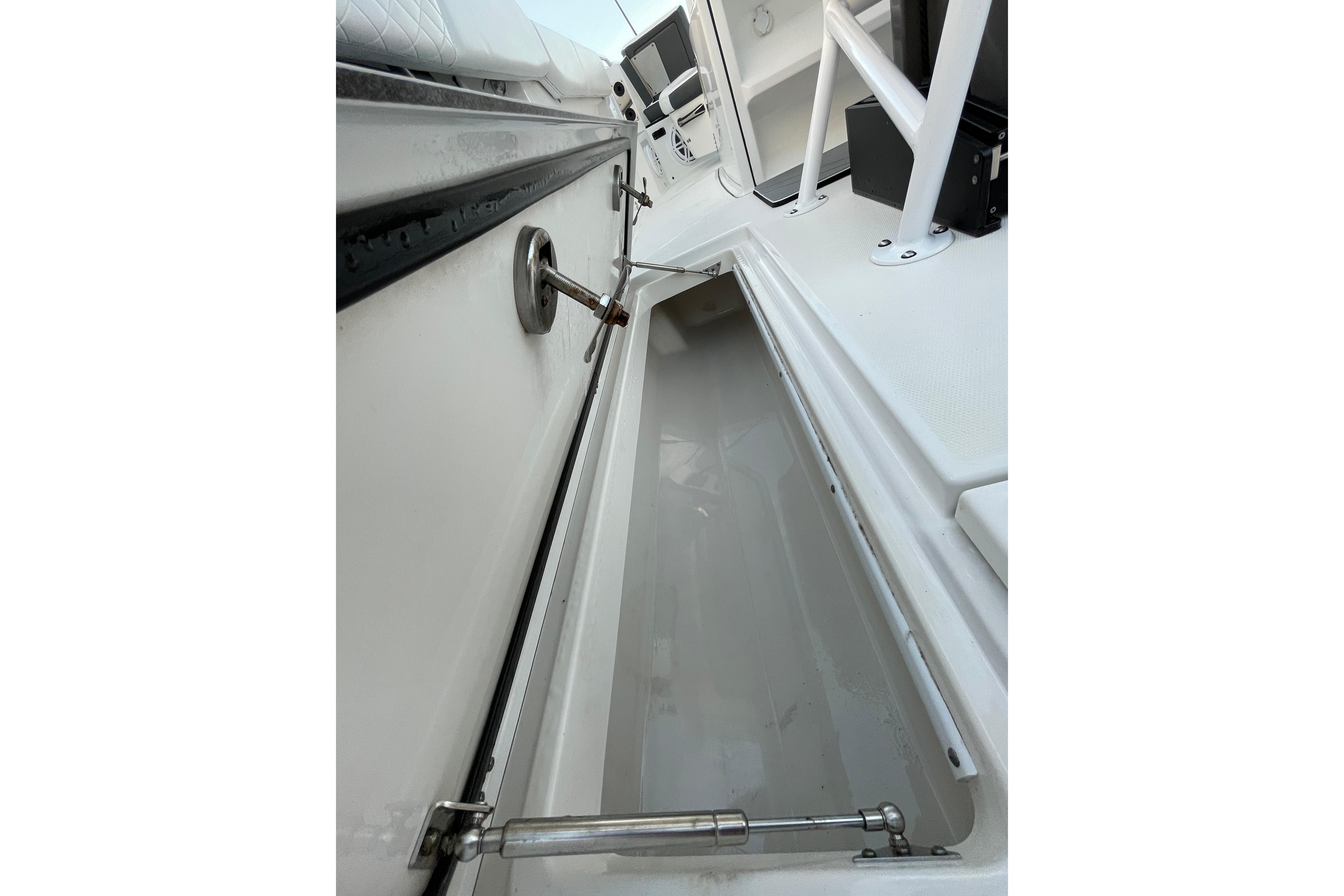 2022 Blackfin 252 CC boat storage compartment with open hatch and hydraulic support.