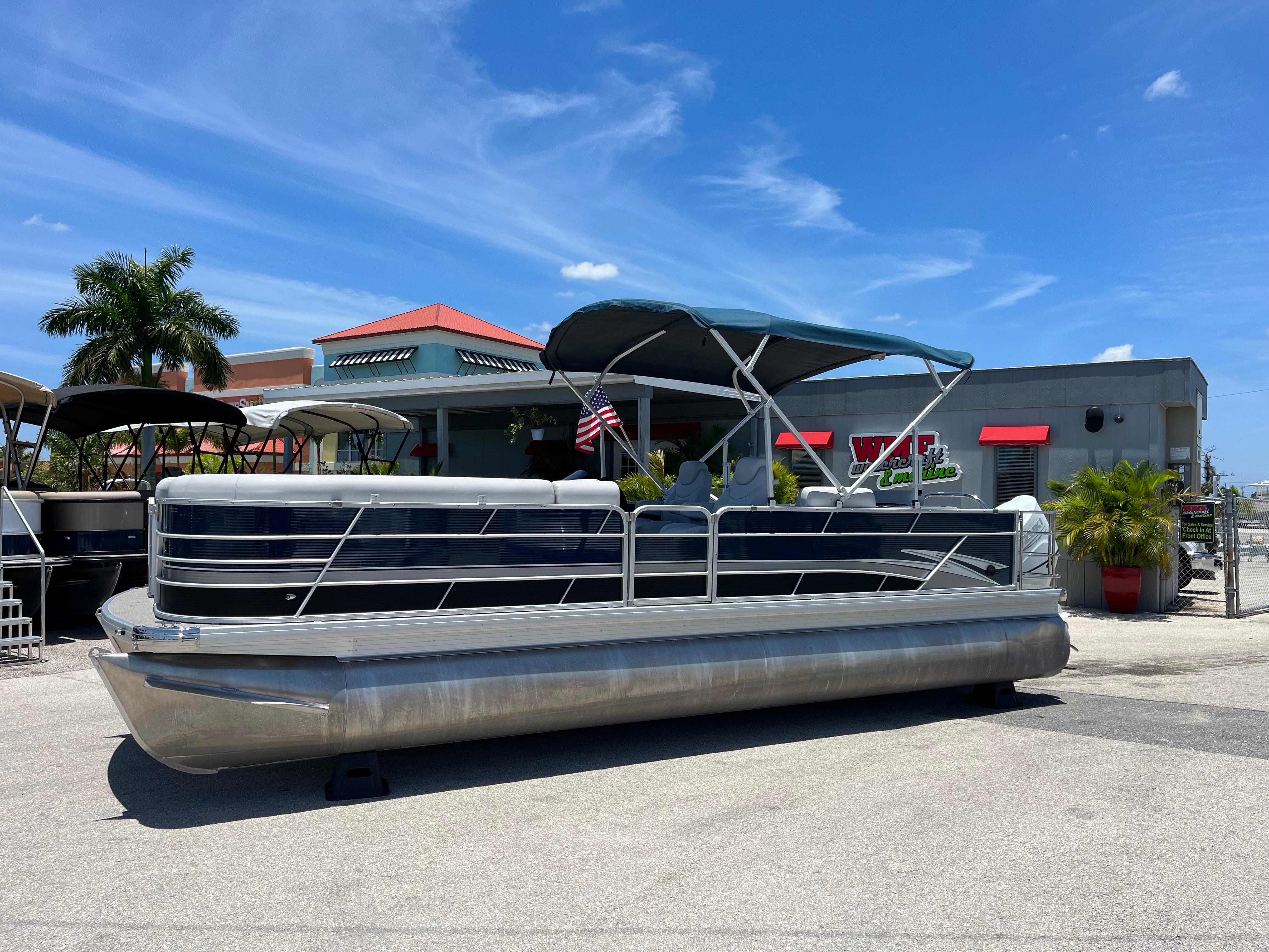 2022 Godfrey SWEETWATER 2486 SFL pontoon boat displayed outdoors on a sunny day.