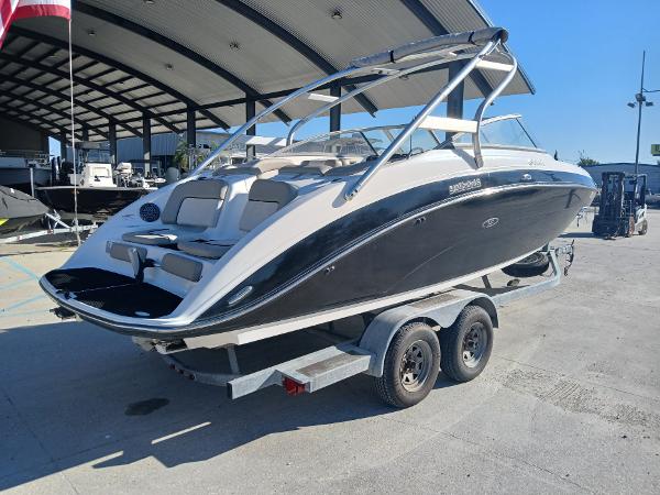 2010 Yamaha Boats 242 Limited on trailer, parked outdoors under a canopy.
