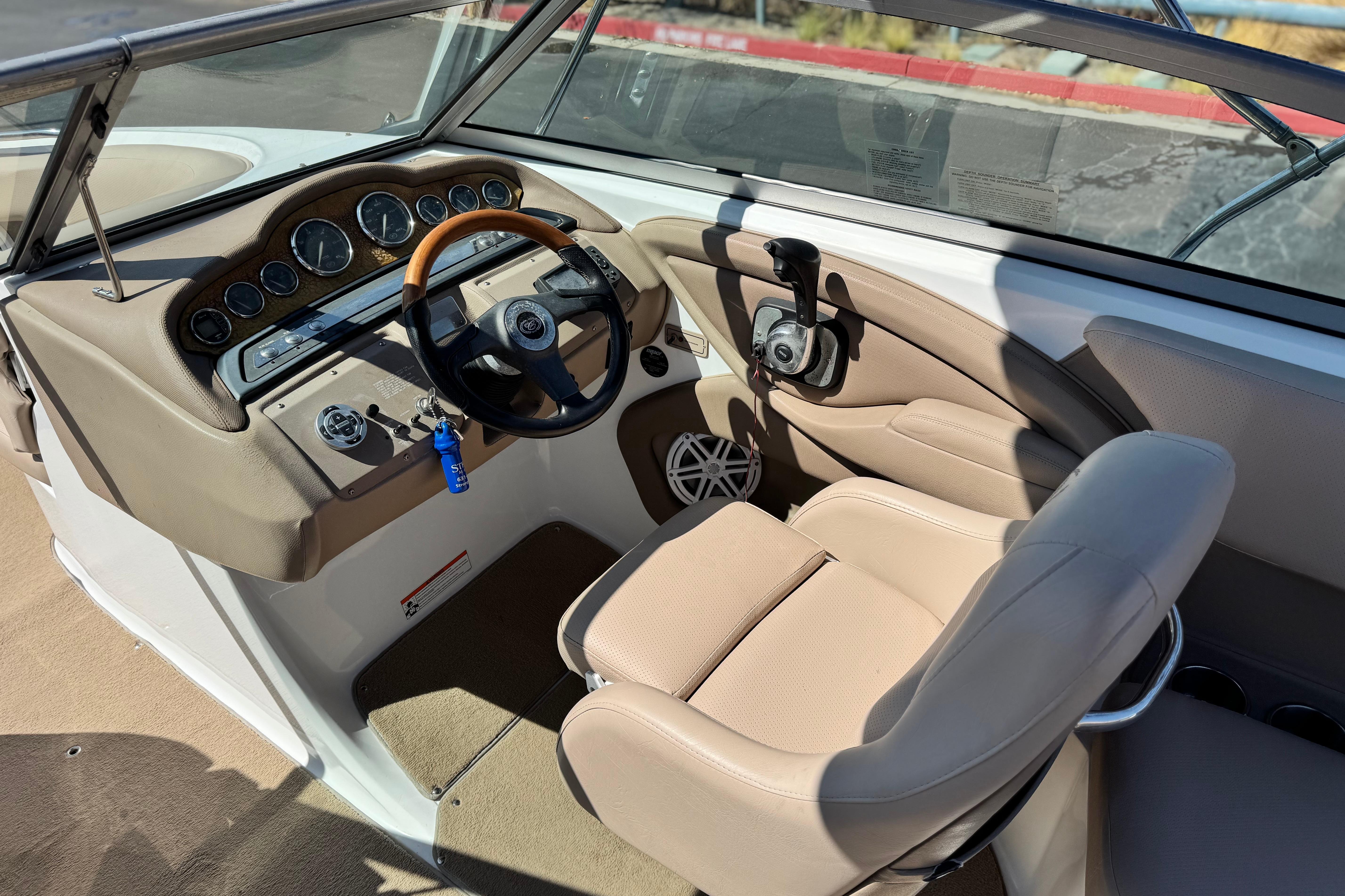 Interior of a 2008 Cobalt 262 boat with beige seating and dashboard controls.