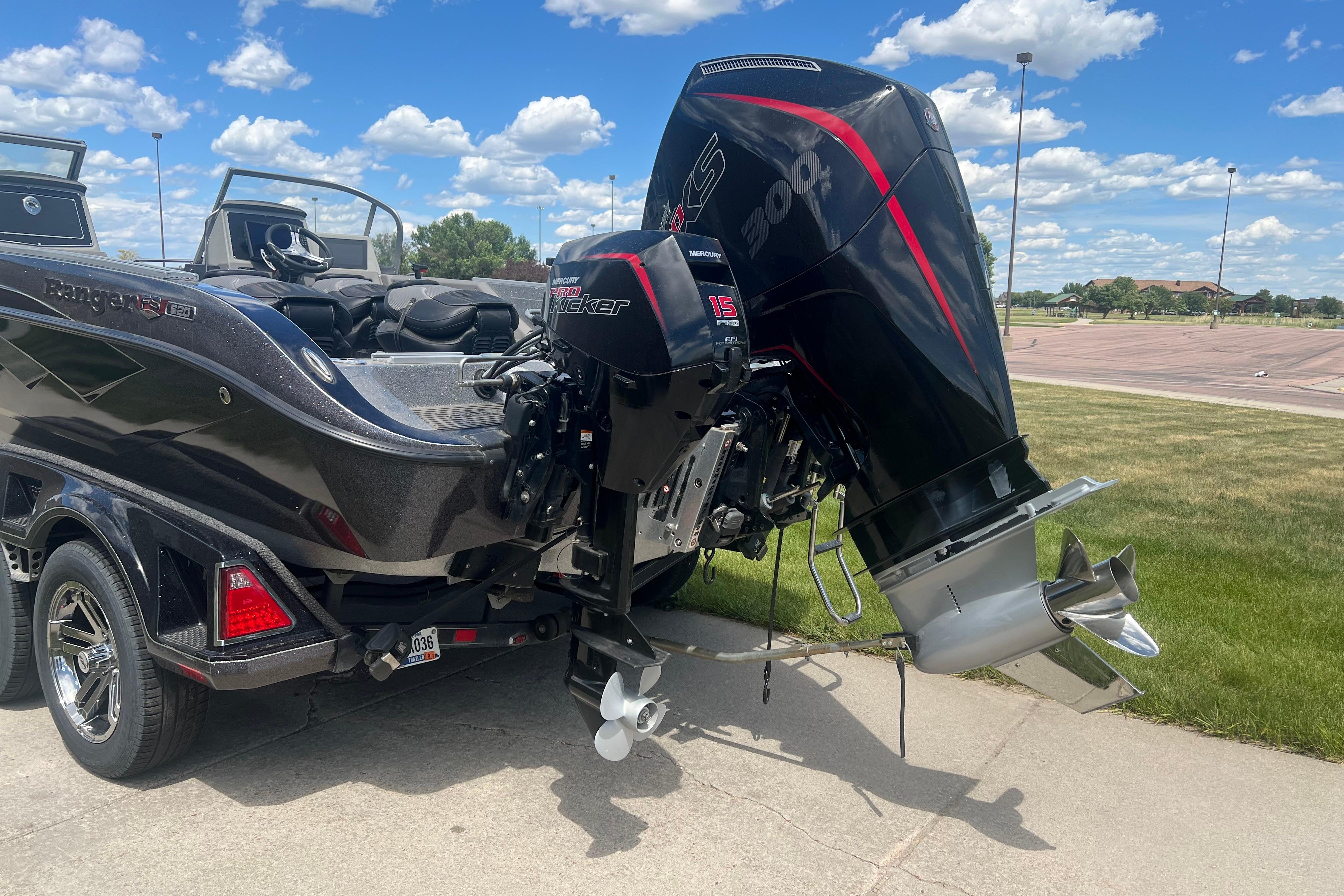 2023 Ranger 620FS Pro boat with powerful Mercury outboard motor, parked on pavement.