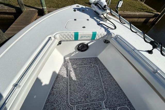 2002 Yellowfin 31 Center Console boat interior with non-slip flooring and fishing rod holders.