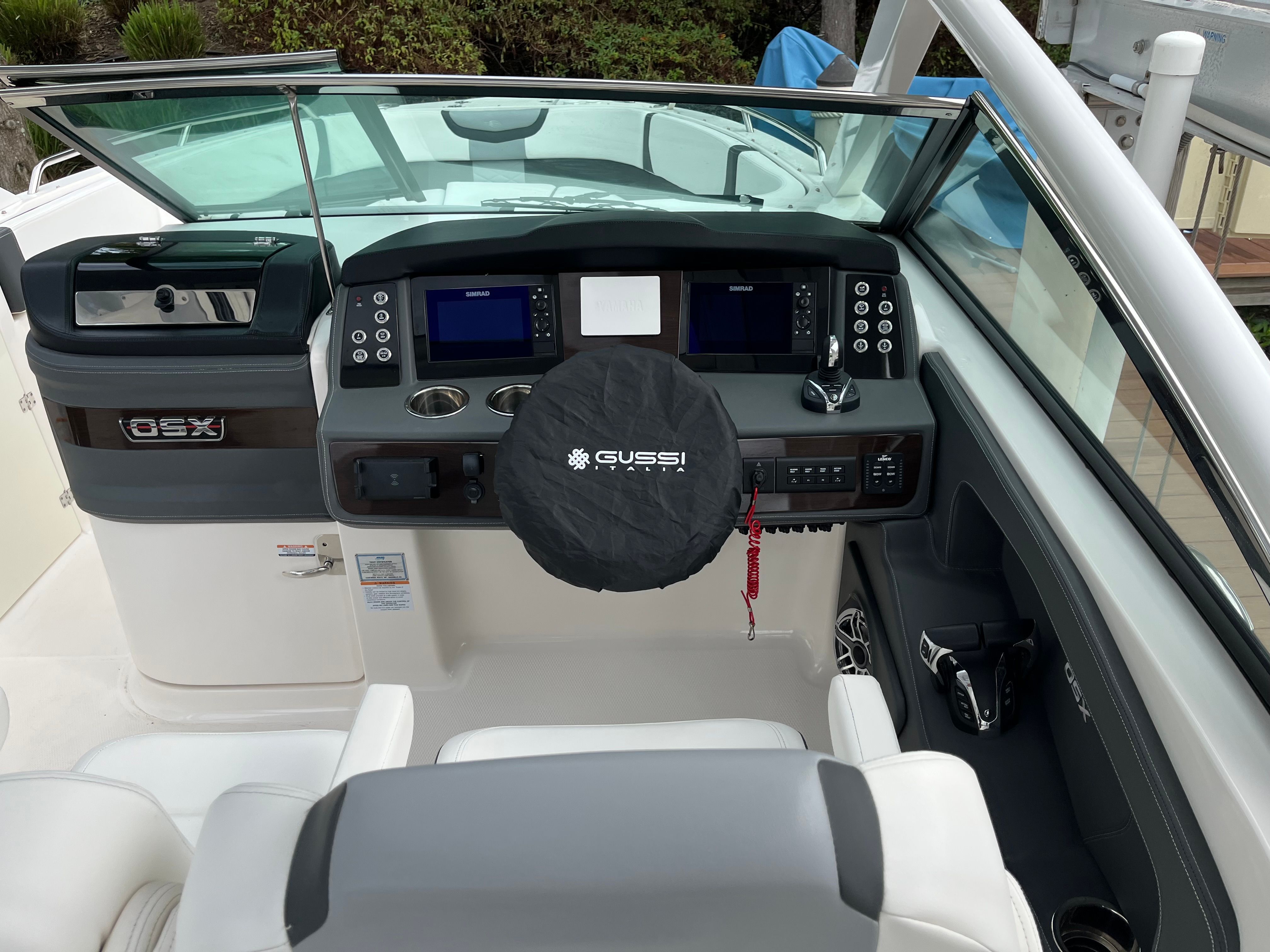 The image shows the cockpit of a 2023 Chaparral 28 OSX boat with modern instruments.