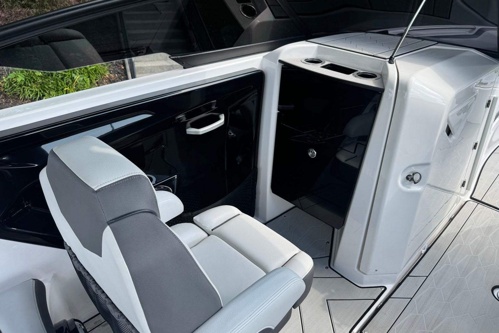 2023 Yamaha Boats 252XE interior with seating and storage compartments.
