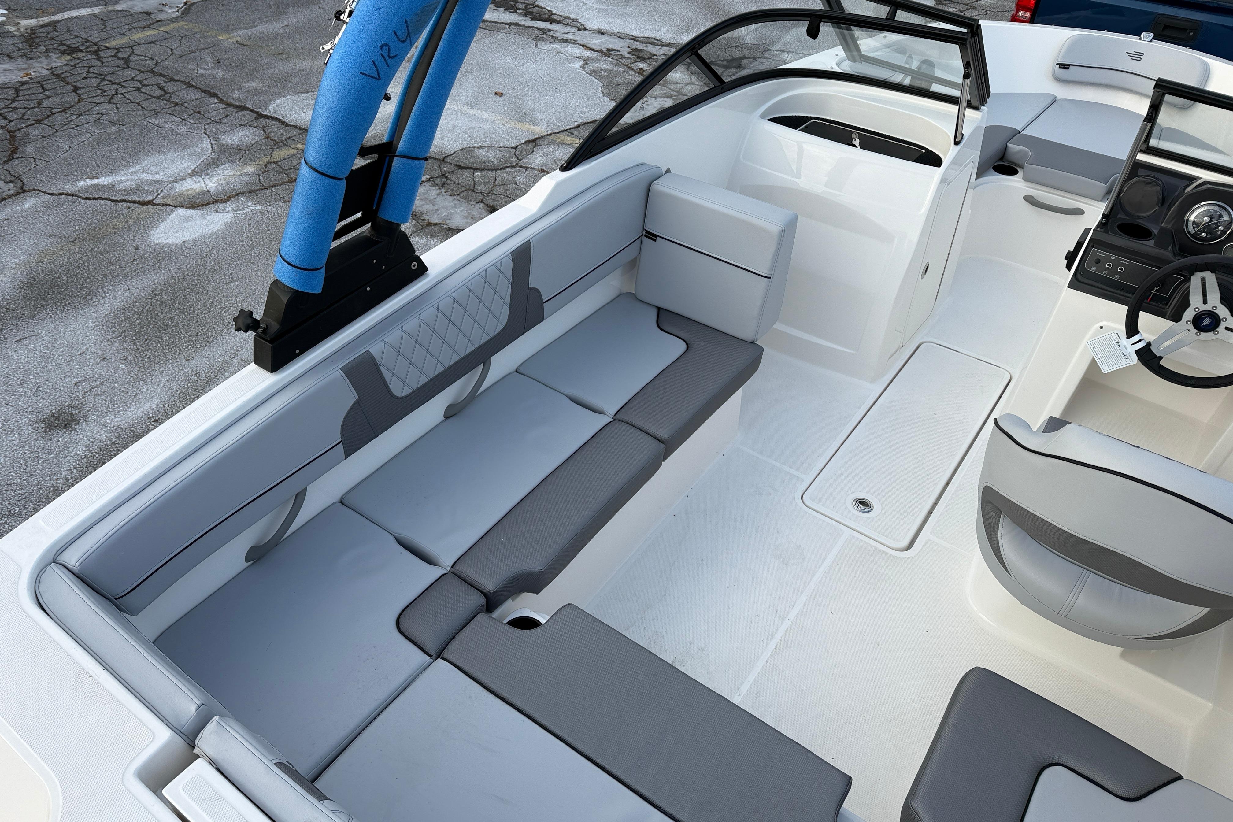 2026 Bayliner VR4 Bowrider OB interior with gray seating and steering wheel.