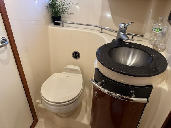 2004 Sea Ray 390 Sundancer bathroom with toilet, sink, and modern fixtures.