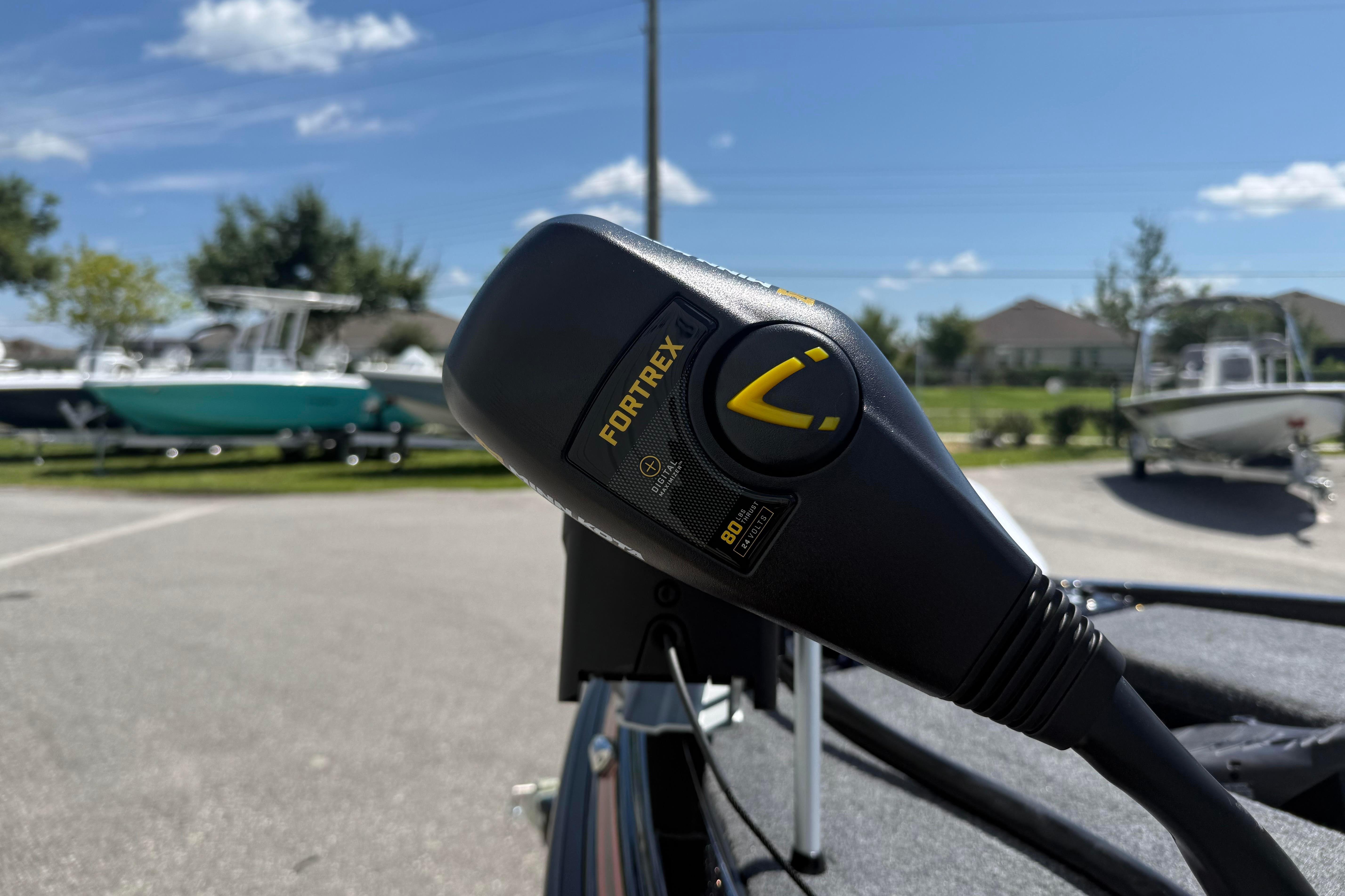 Close-up of Fortrex motor on Phoenix 919 ZXL boat, 2027 model, in a sunny outdoor setting.