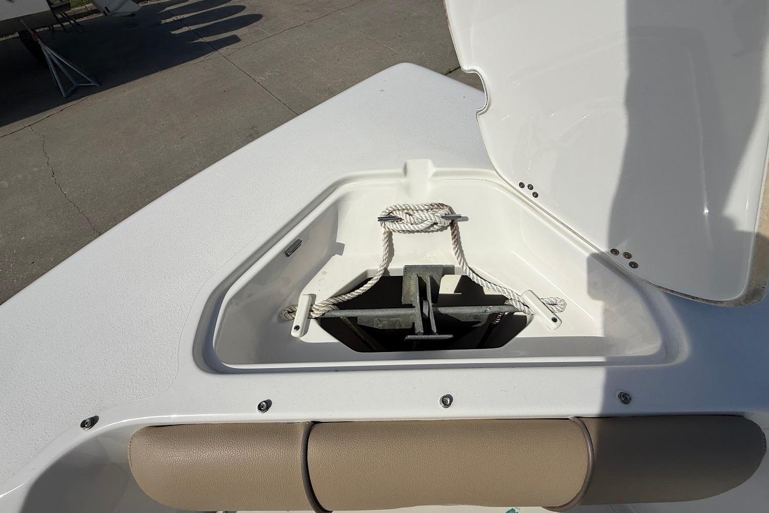 Open anchor compartment on 2019 Key West 203 DFS boat, showing anchor and rope.