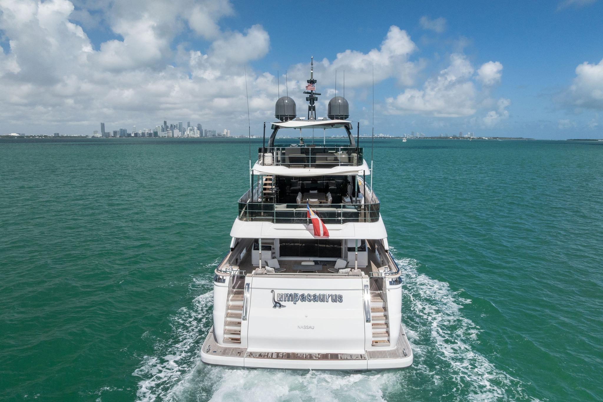Luxurious 2023 Custom Line Navetta 33 yacht cruising on turquoise waters under a clear sky.