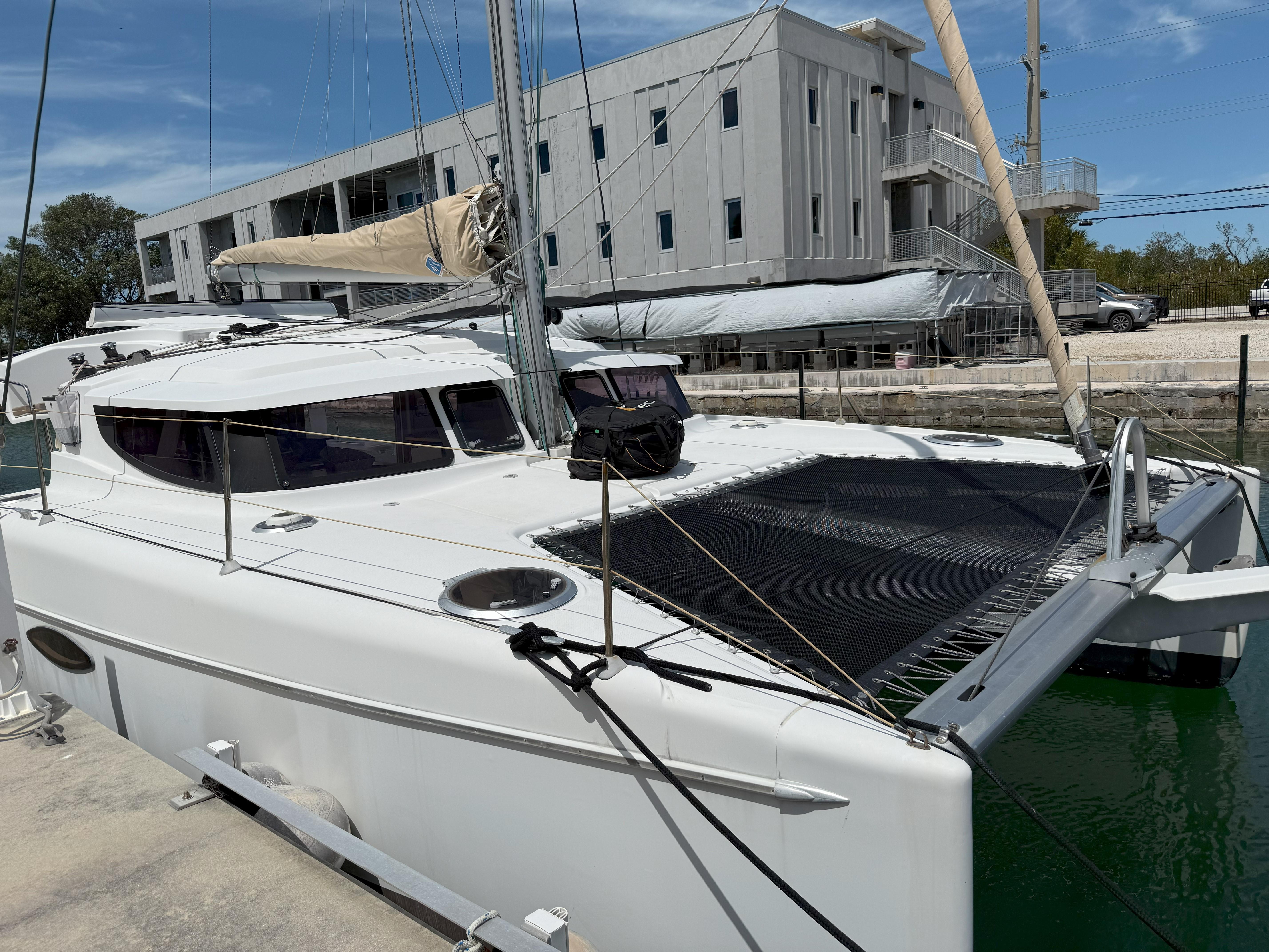 2014 Fountaine Pajot Mahe 36 Evolution catamaran docked, featuring sleek design and spacious deck.