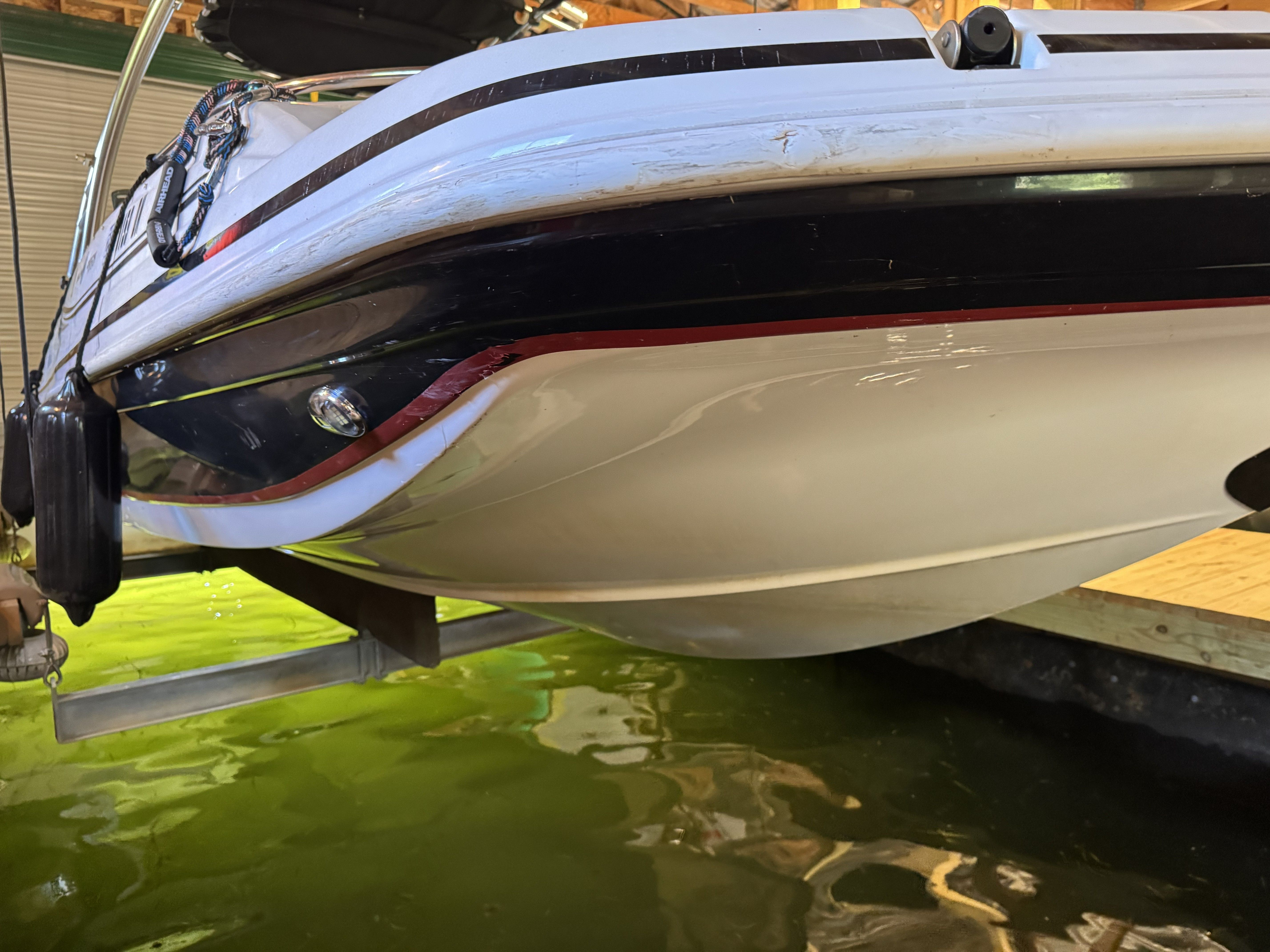 A 2014 Hurricane SS201 I/O is in the water, featuring a sleek white hull.