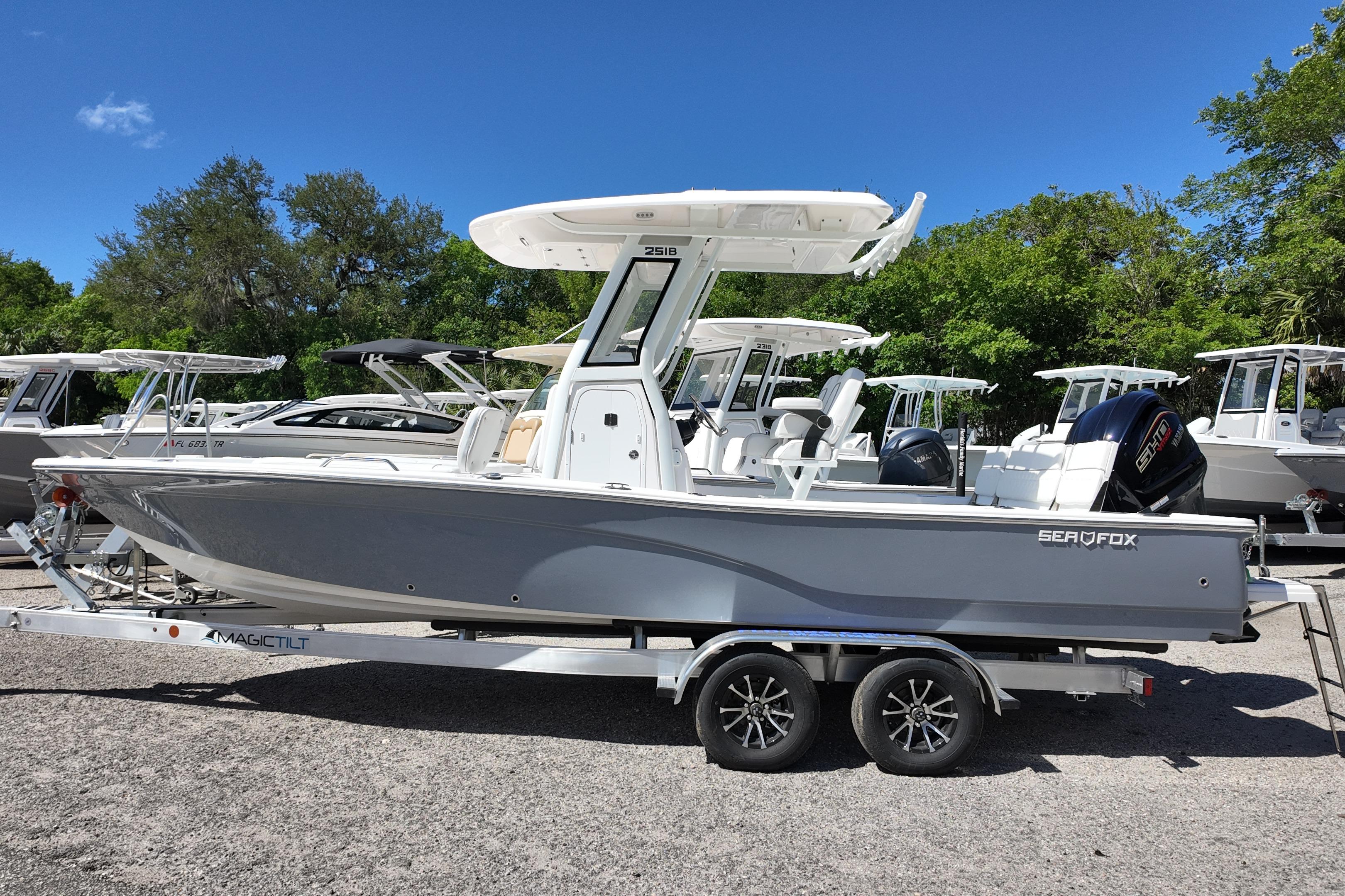 2026 Sea Fox 251 Bay Fox boat on trailer, parked outdoors under clear blue sky.