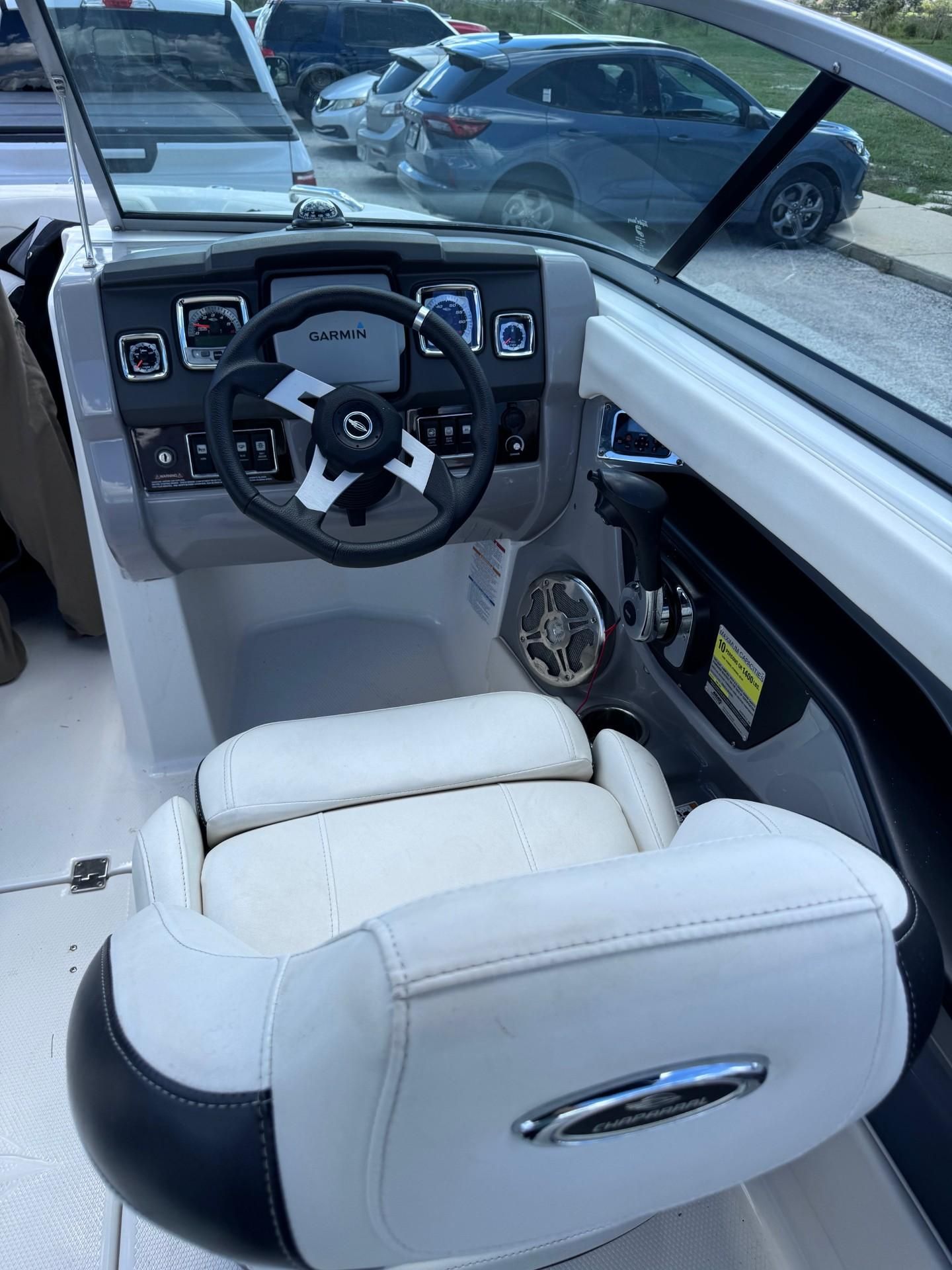 The image shows the cockpit of a 2013 Chaparral 206 SSi boat with a Garmin display.