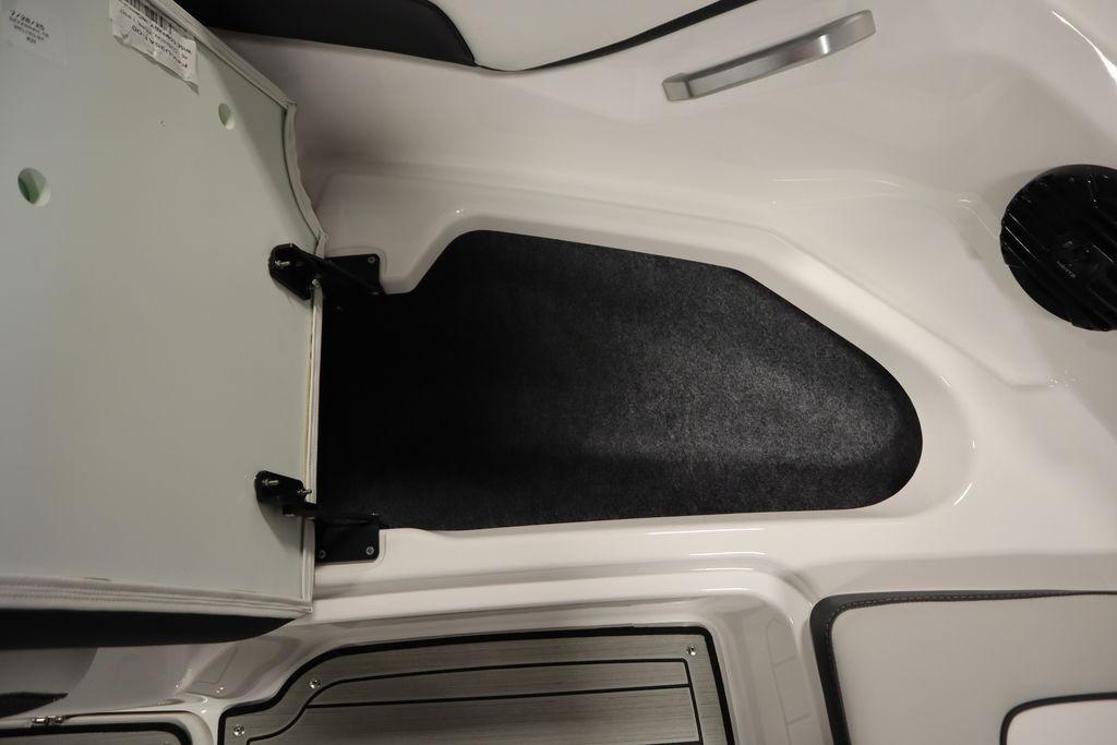 2026 Yamaha Boats 195S interior storage compartment with open hatch and carpeted flooring.