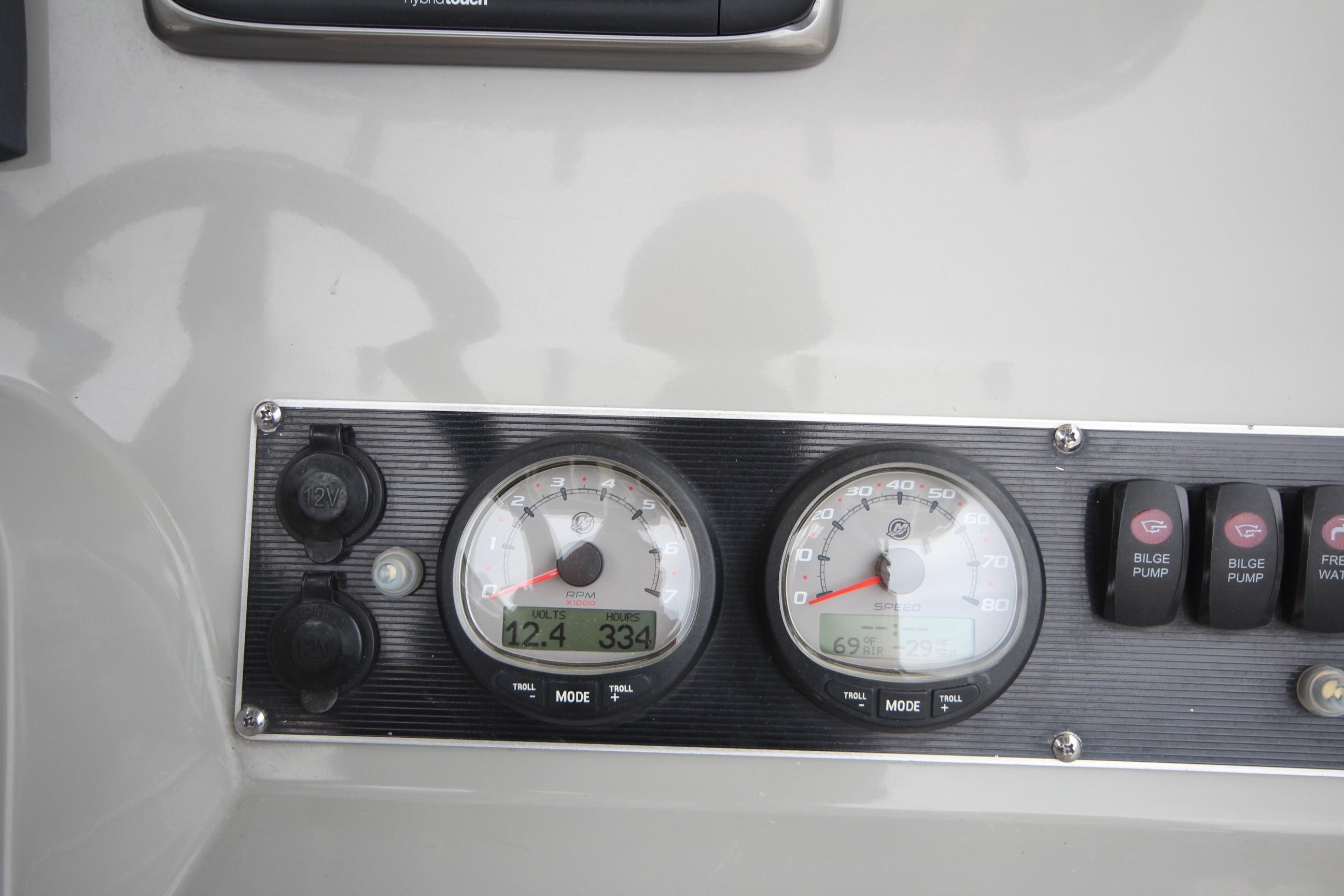 Dashboard of a 2014 Boston Whaler 210 Dauntless boat with gauges and switches.