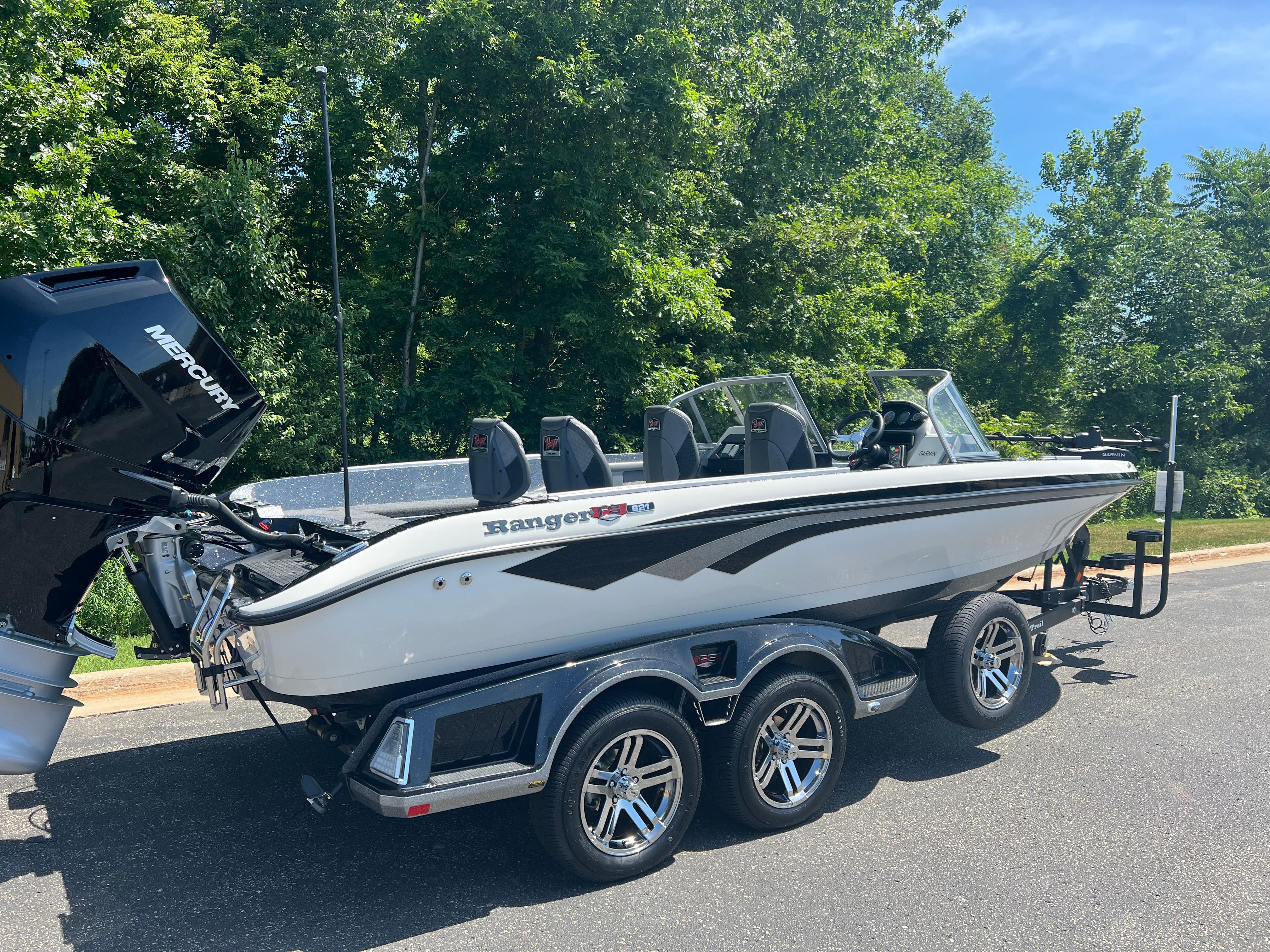 2025 Ranger 621FS Cup Equipped boat on trailer, parked outdoors with trees in background.